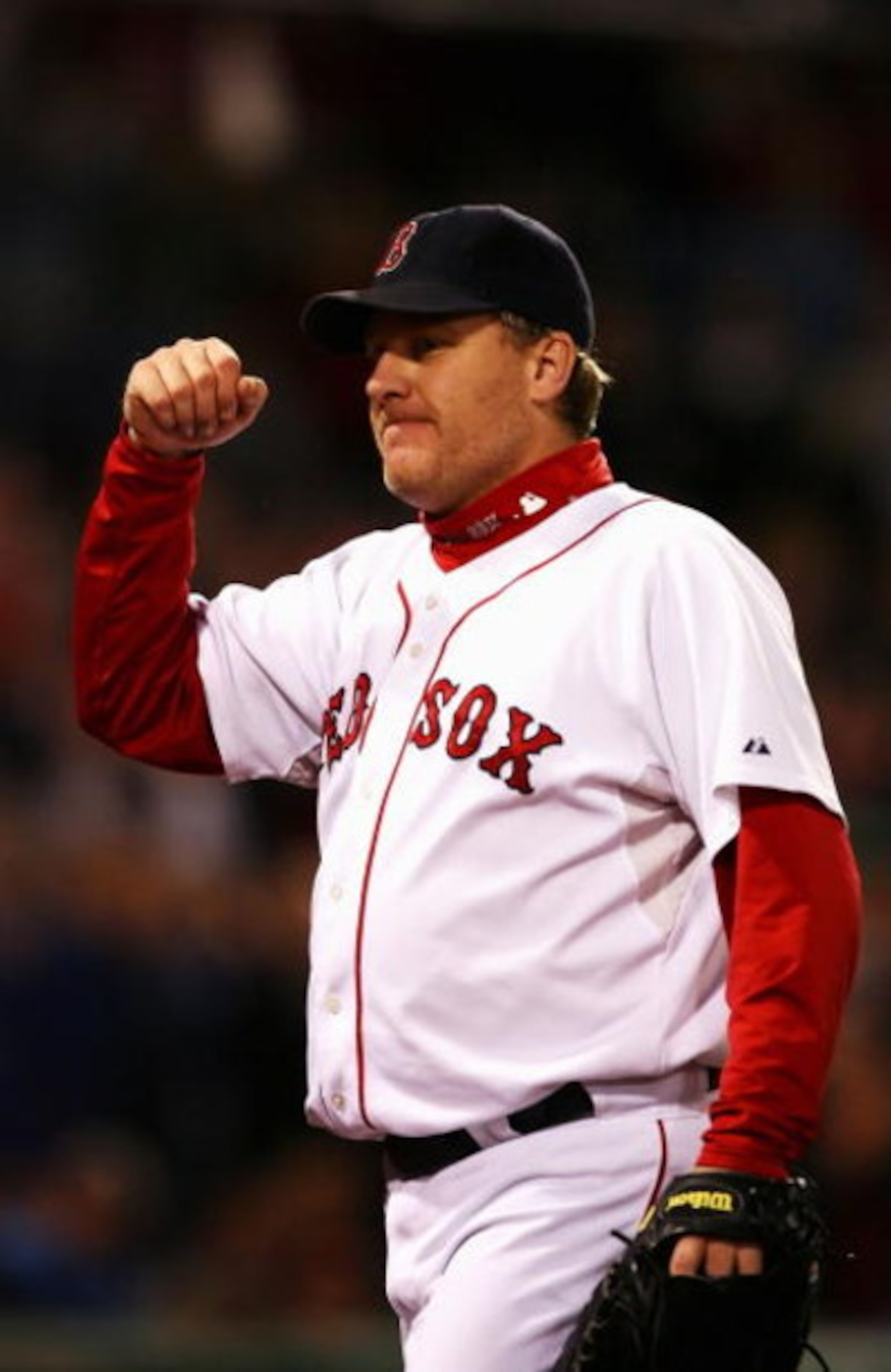 BOSTON - OCTOBER 20:  Starting pitcher Curt Schilling #38 of the Boston Red Sox smiles as he leaves the game after closing out the seventh inning against the Cleveland Indians during Game Six of the American League Championship Series at Fenway Park on Oc