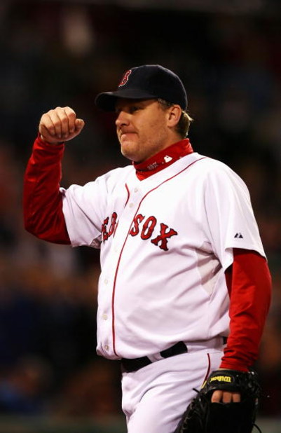 BOSTON - OCTOBER 20:  Starting pitcher Curt Schilling #38 of the Boston Red Sox smiles as he leaves the game after closing out the seventh inning against the Cleveland Indians during Game Six of the American League Championship Series at Fenway Park on Oc