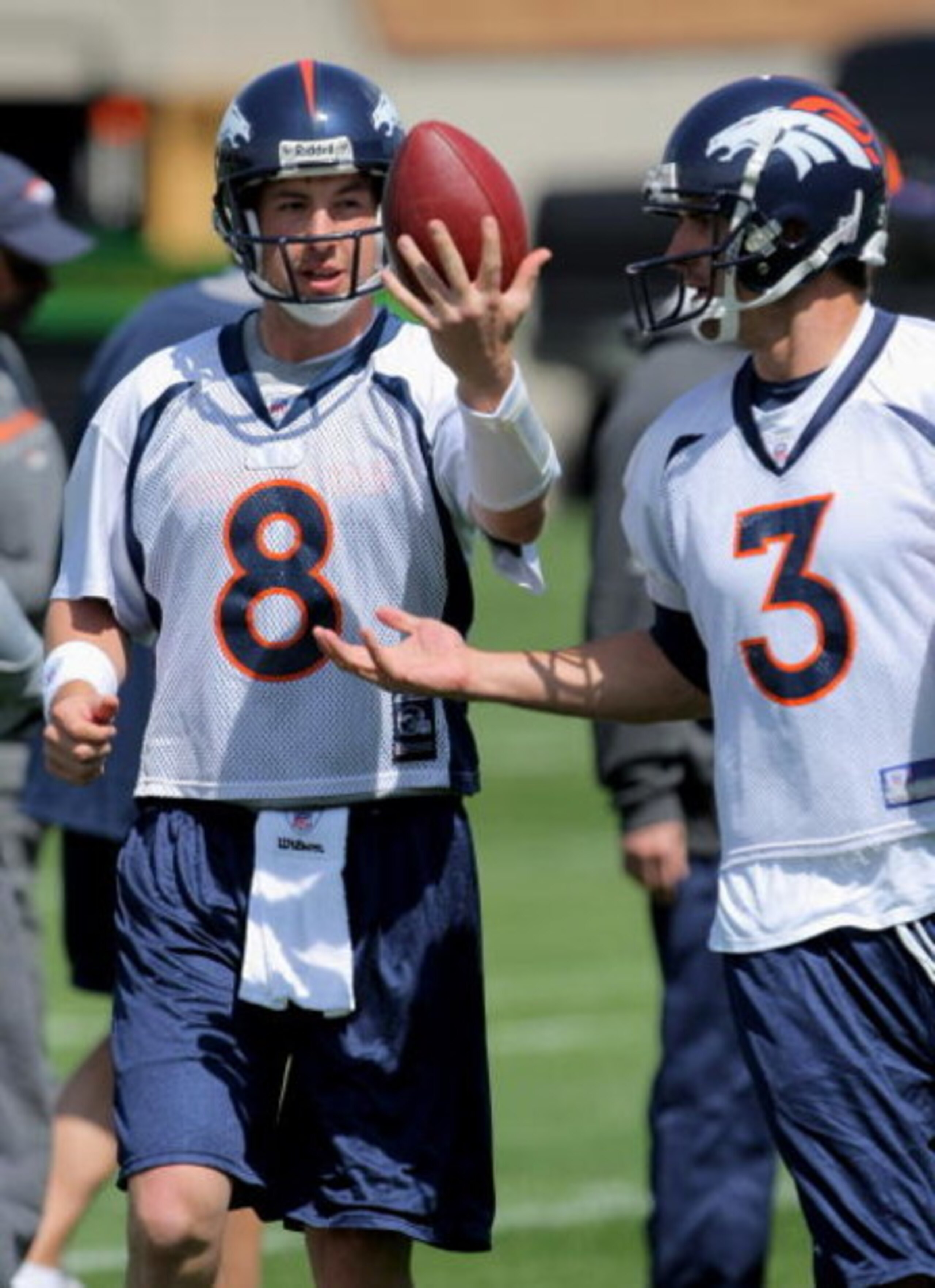 ENGLEWOOD, CO - MAY 03:  Quarterback Kyle Orton #8 has the ball jokingly tipped form his hands by sixth round draft pick rookie quarterback Tom Brandslater #3 during Denver Broncos Minicamp at the Broncos training facility on May 3, 2009 in Englewood, Col