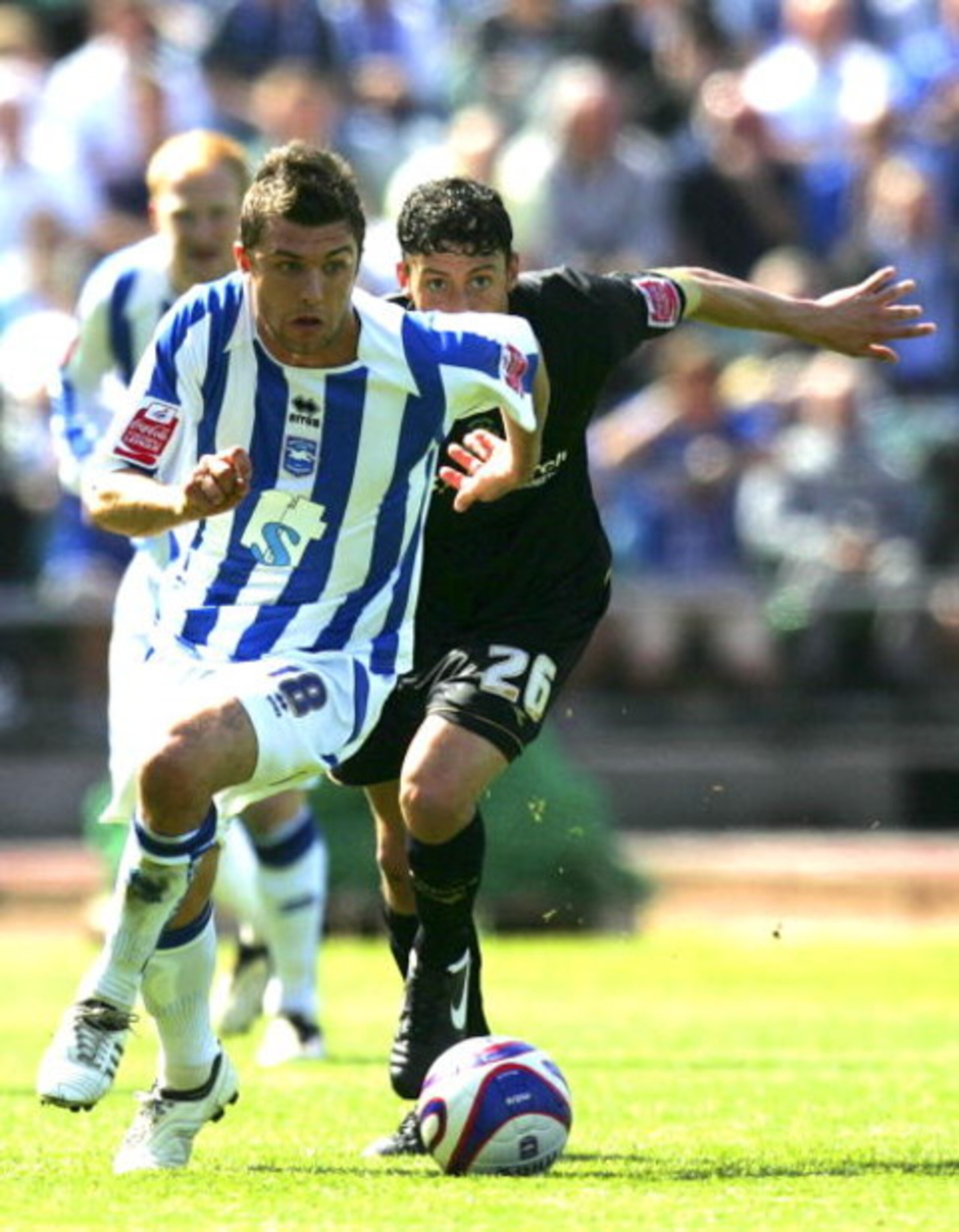 BRIGHTON, UNITED KINGDOM - MAY 02: Doug Loft of Brighton & Hove Albion and Matty Mainwaring of Stockport County run to the ball during the Coca Cola League One match between Brighton & Hove Albion and Stockport County at Withdean Stadium on May 02, 2009 i