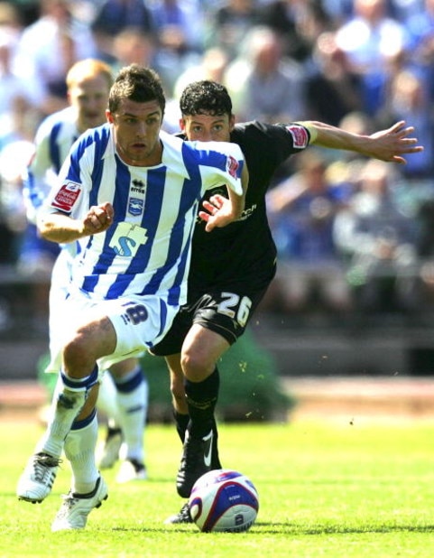 BRIGHTON, UNITED KINGDOM - MAY 02: Doug Loft of Brighton & Hove Albion and Matty Mainwaring of Stockport County run to the ball during the Coca Cola League One match between Brighton & Hove Albion and Stockport County at Withdean Stadium on May 02, 2009 i
