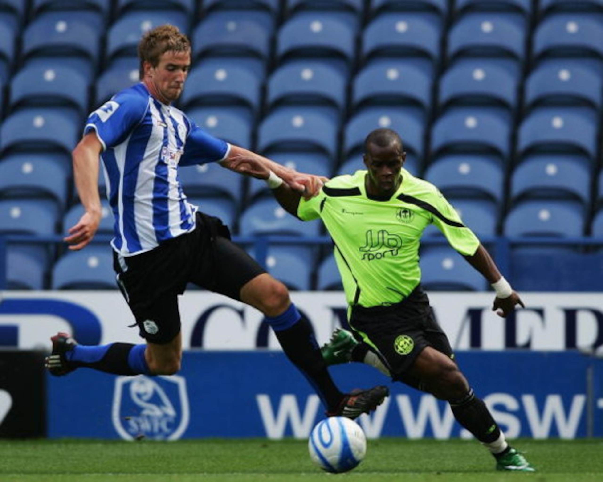 SHEFFIELD, UNITED KINGDOM - AUGUST 02:  Henri Camara of Wigan Athletic holds off Mark Beevers of Sheffield Wednesday (L) during the pre season friendly match between Sheffield Wednesday and Wigan Athletic at Hillsborough on August 2, 2008 in Sheffield, En