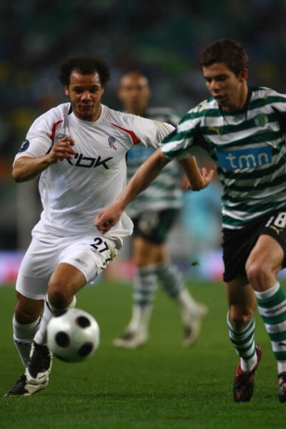 LISBON, PORTUGAL - MARCH 13:  Danny Braaten (left) of Bolton chases down Grimi during the UEFA Cup Round of 16 second leg match between Sporting Lisbon and Bolton Wanderers at the Alvalade XXI Stadium on March 13, 2008 in Lisbon, Portugal.  (Photo by Mich