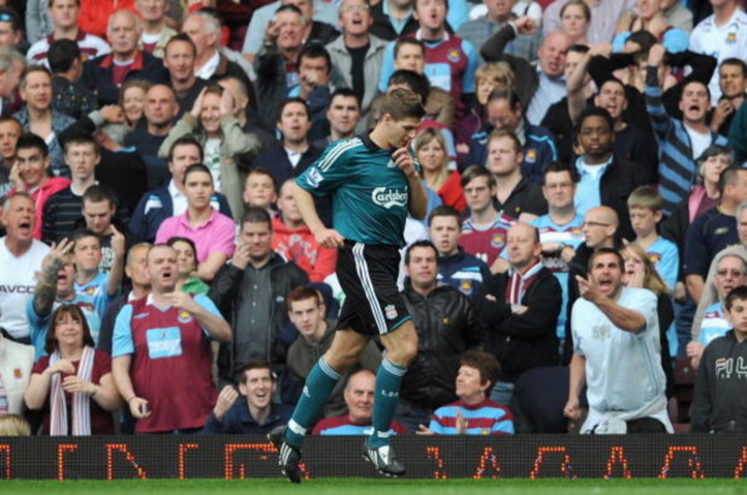 LONDON, ENGLAND - MAY 09:  Steven Gerrard of Liverpool holds his finger to his lips to silence the crowd after he scores from the rebound of his penalty during the Barclays Premier League match between West Ham United and Liverpool at Upton Park on May 9,