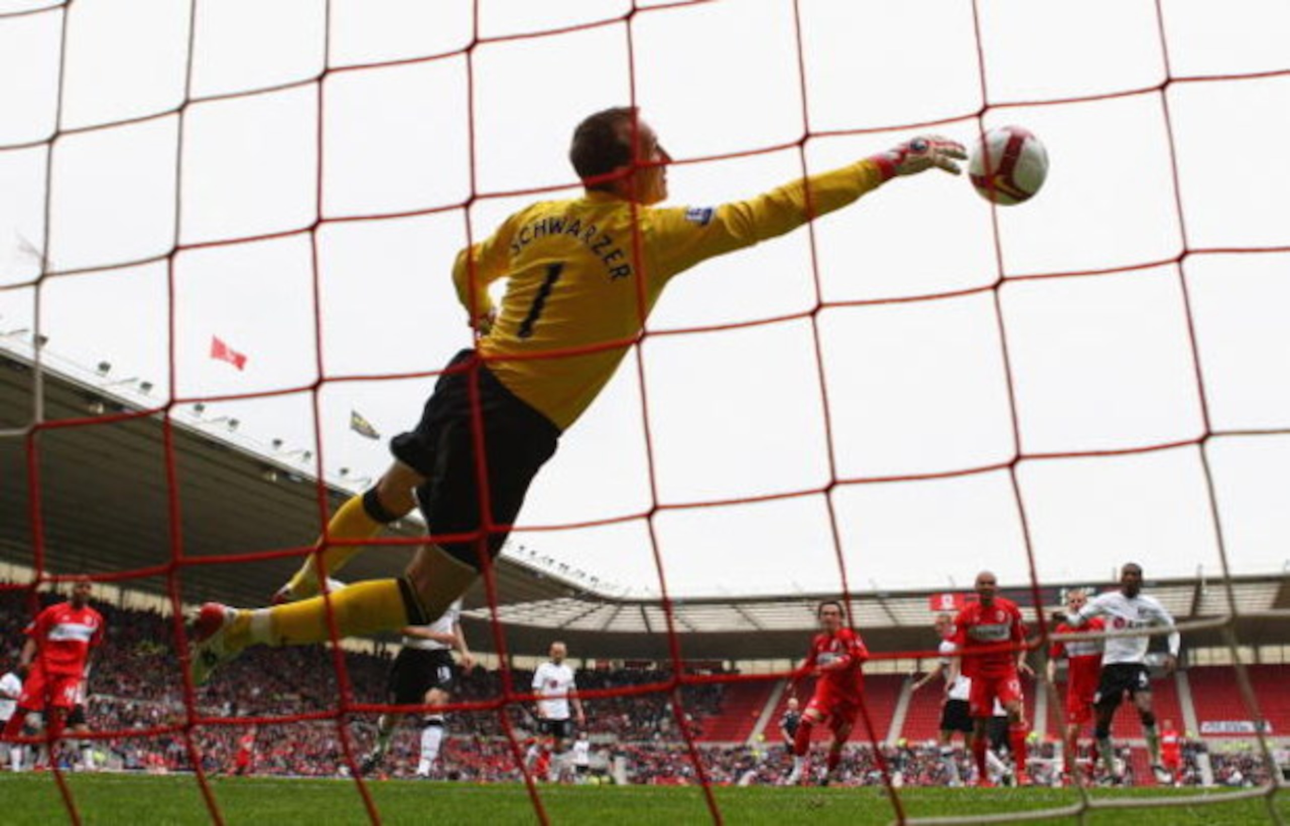 MIDDLESBROUGH, ENGLAND - APRIL 18:  Mark Schwarzer of Fulham makes a diving save against his former club during the Barclays Premier League match between Middlesbrough and Fulham at the Riverside Stadium on April 18, 2009 in Middlesbrough, England.  (Phot