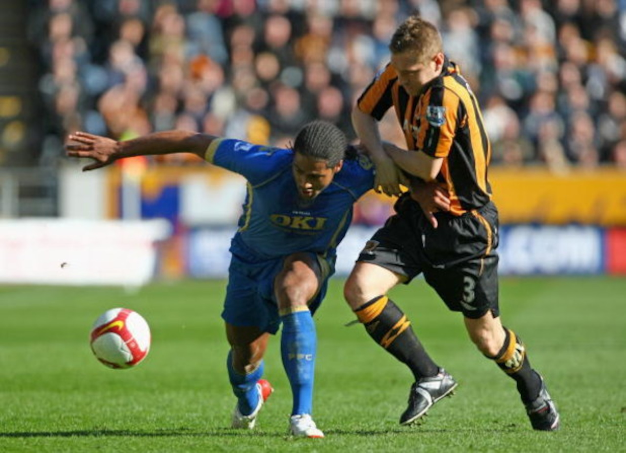 HULL, ENGLAND - APRIL 04:  Glen Johnson of Portsmouth challenges Andrew Dawson of Hull City during the Barclays Premier League match between Hull City and Portsmouth at the KC Stadium on April 4, 2009 in Hull, England.  (Photo by Clive Rose/Getty Images)
