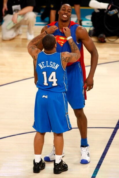 NEW ORLEANS - FEBRUARY 16:  Dwight Howard of the Orlando Magic gets help from teammate Jameer Nelson to put on a Superman costume for Howard's second dunk of the Sprite Slam Dunk Contest, part of 2008 NBA All-Star Weekend at the New Orleans Arena on Febru