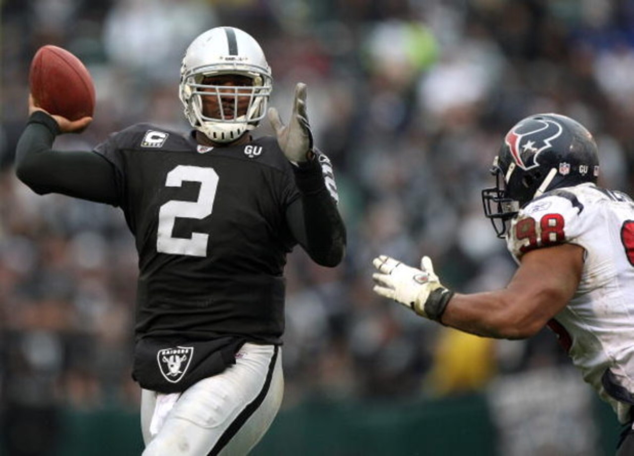 OAKLAND, CA - DECEMBER 21: JaMarcus Russell #2 of the Oakland Raiders passes against Anthony Weaver #98 of the Houston Texans during an NFL game on December 21, 2008 at the Oakland-Alameda County Coliseum in Oakland, California.  (Photo by Jed Jacobsohn/G