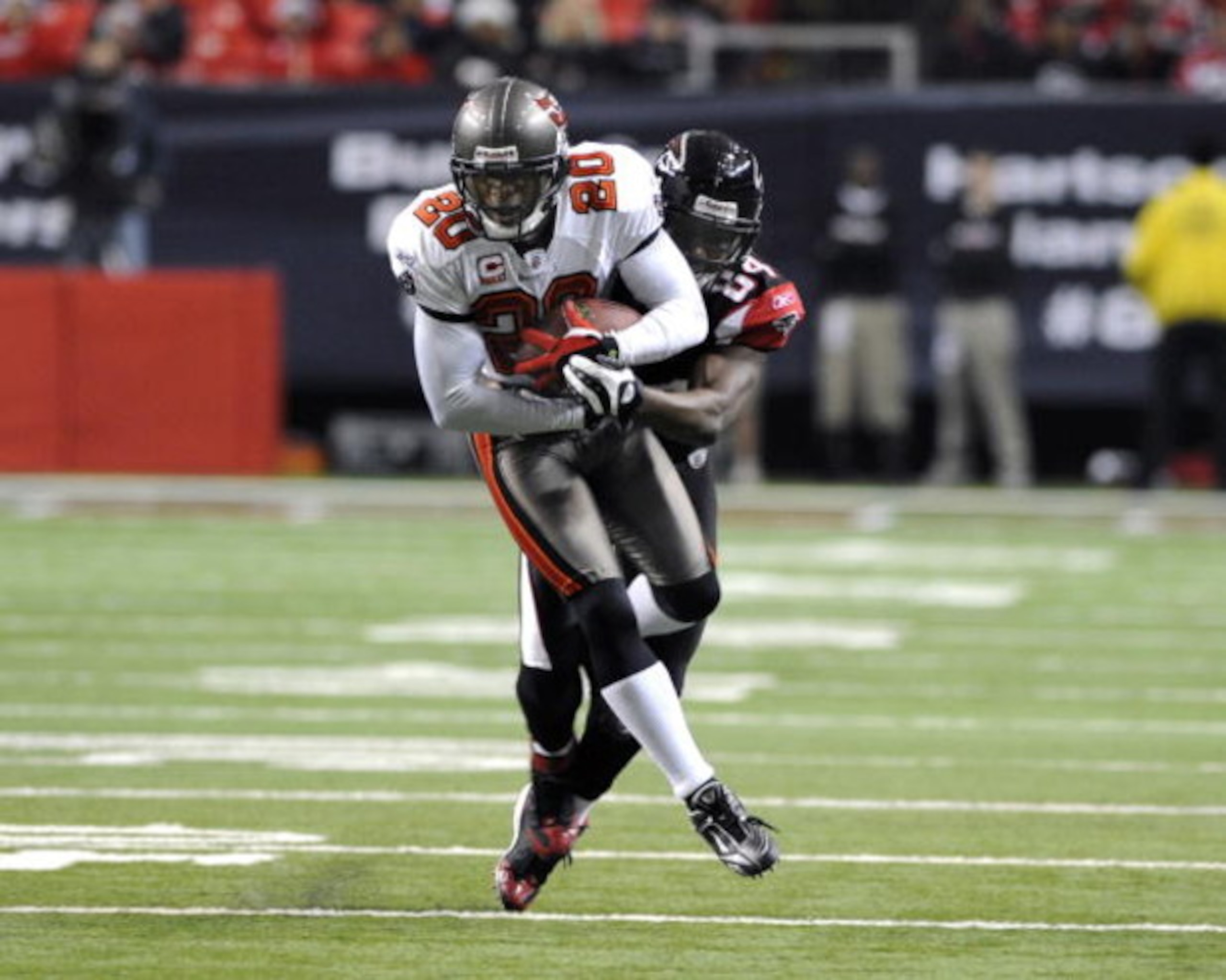 ATLANTA - DECEMBER 14:  Cornerback Ronde Barber #20 of the Tampa Bay Buccaneers intercepts a second-quarter pass against the Atlanta Falcons at the Georgia Dome on December 14, 2008 in Atlanta, Georgia.  (Photo by Al Messerschmidt/Getty Images)