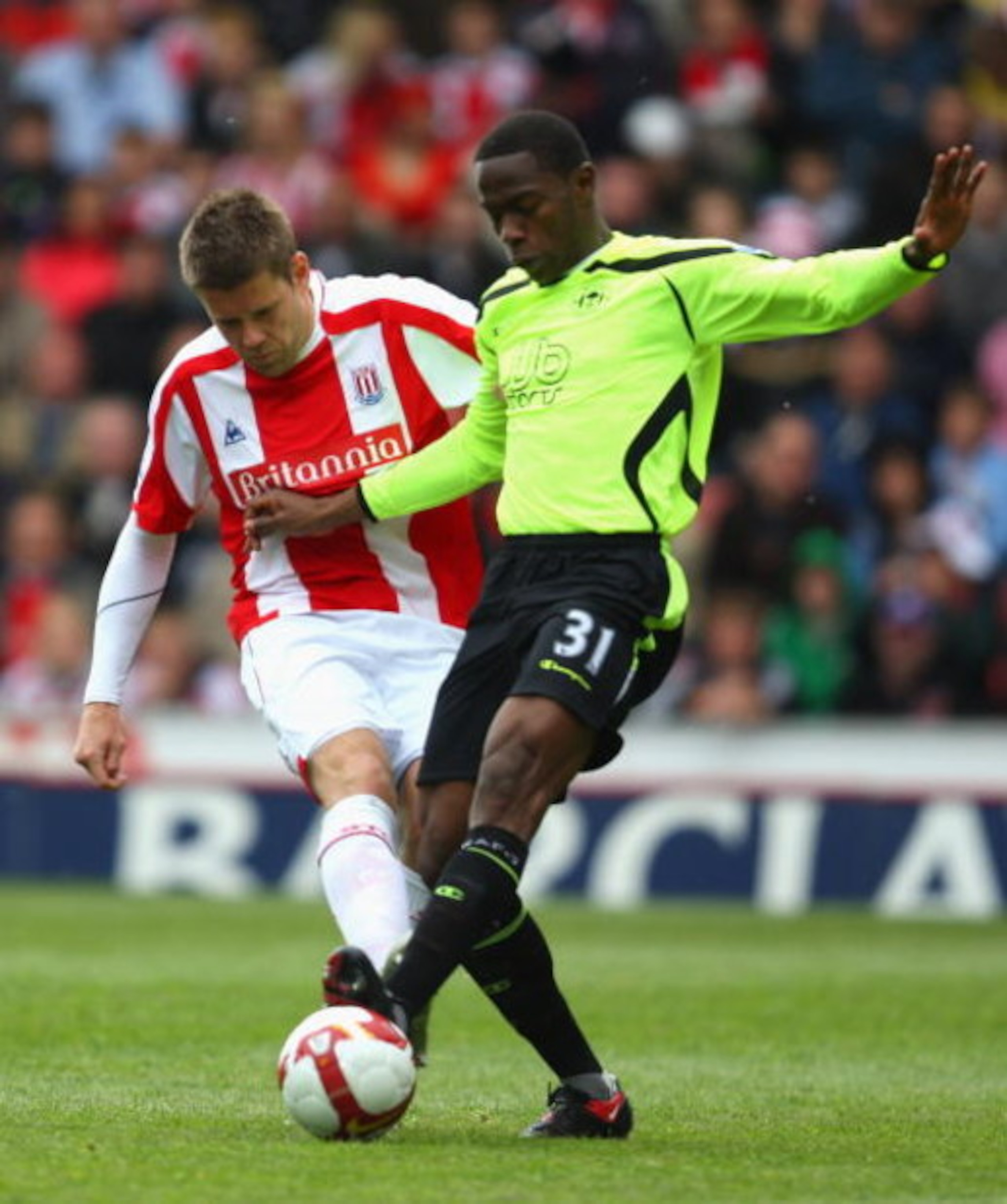 STOKE, ENGLAND - MAY 16:   James Beattie of Stoke is challenged by Maynor Figueroa of Wigan Athletic during the Barclays Premier League match between Stoke City and  Wigan Athletic at the Britannia Stadium on May 16, 2009 in Stoke, England.  (Photo by Mar