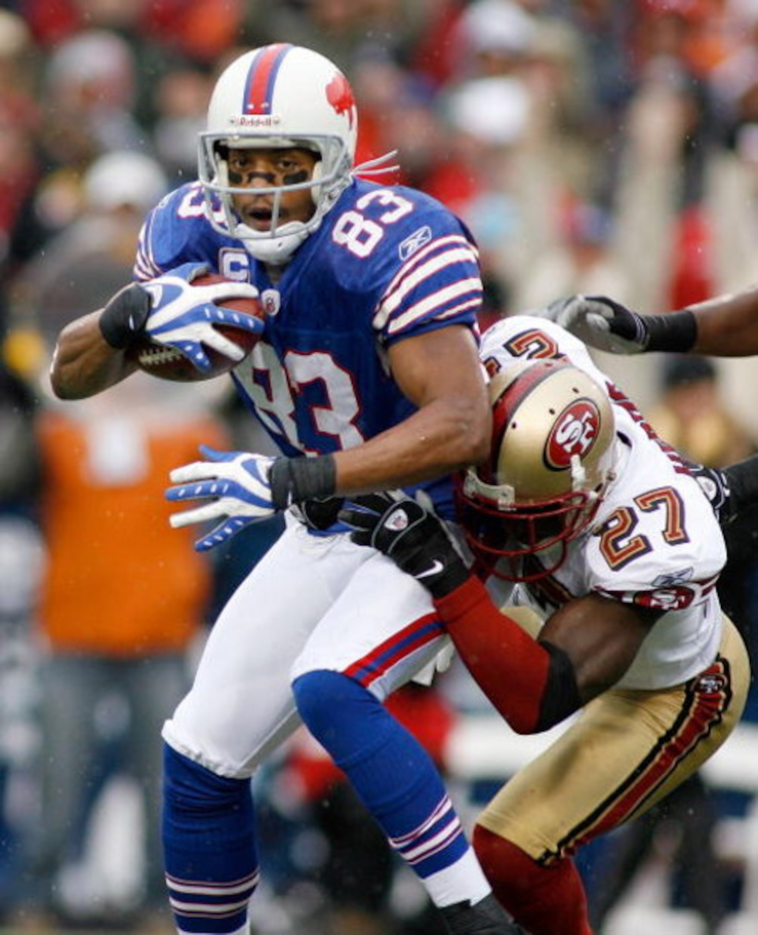 ORCHARD PARK, NY - NOVEMBER 30: Lee Evans #83  of the Buffalo Bills is tackled by Walt Harris #27 of the San Francisco 49ers  on November 30, 2008 at Ralph Wilson Stadium in Orchard Park, New York.  (Photo by Rick Stewart/Getty Images)
