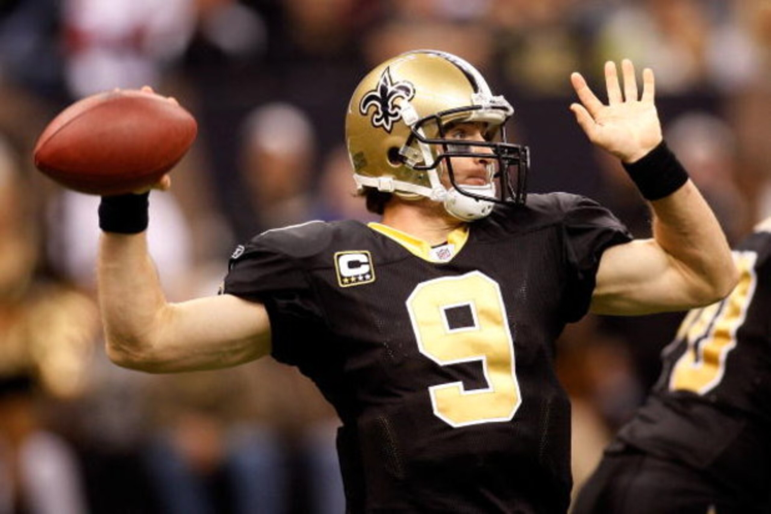 NEW ORLEANS - DECEMBER 07:  Quarterback Drew Brees #9 of the New Orleans Saints throws a pass against the Atlanta Falcons on his way to a 36 yard gain on December 7, 2008 at the Superdome in New Orleans, Louisiana.   The Saints defeated the Falcons 29-25.