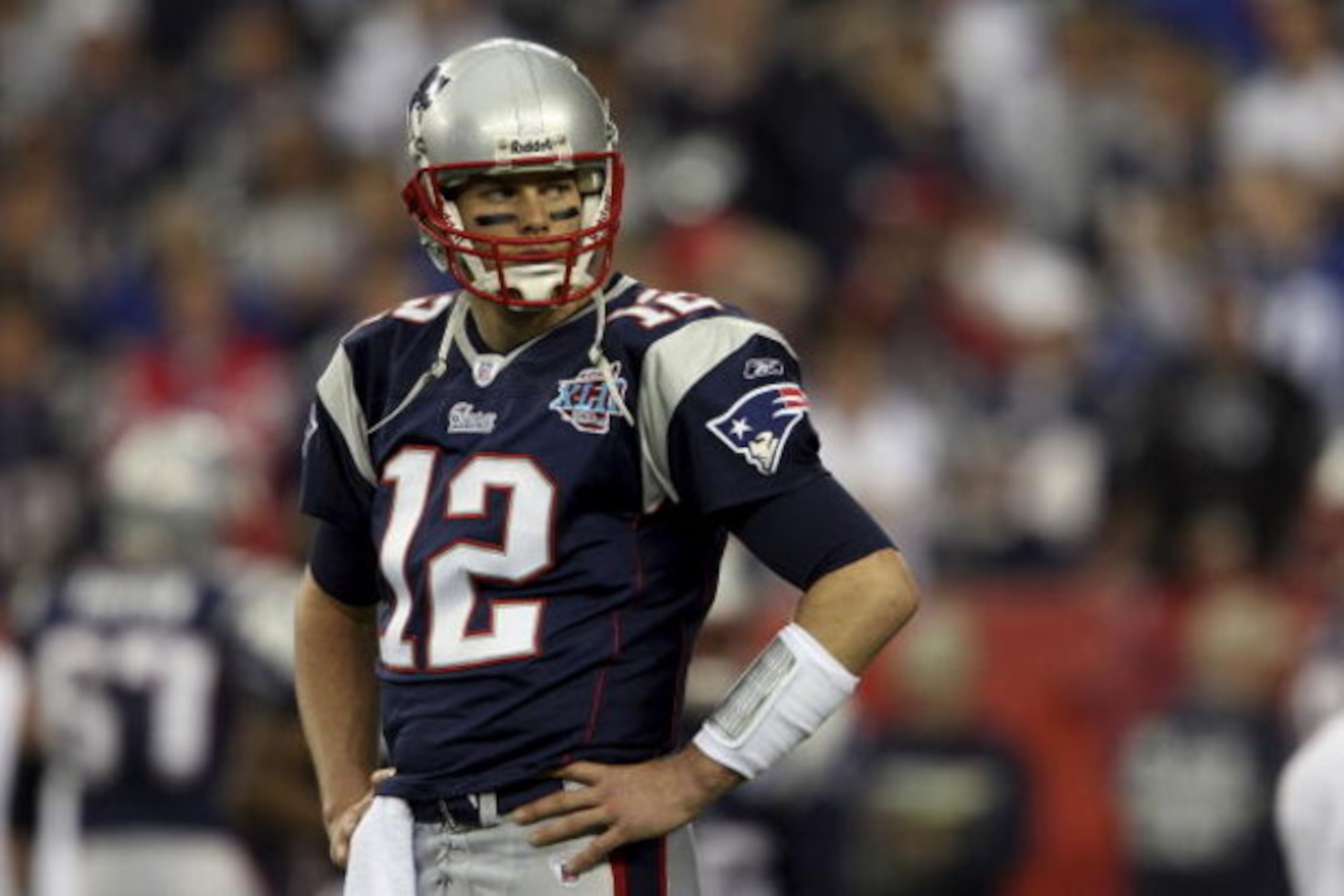 GLENDALE, AZ - FEBRUARY 03:  Quarterback Tom Brady #12 of the New England Patriots looks on during Super Bowl XLII against the New York Giants on February 3, 2008 at the University of Phoenix Stadium in Glendale, Arizona. The Giants defeated the Patriots 