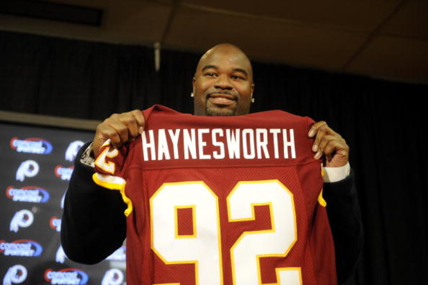 ASHBURN, VA - FEBRUARY 27:  Albert Haynesworth posese with his new jersey at a press conference after signing a 7-year contract worth approximately $100 million with the Washington Redskins on February 27, 2009 at Redskins Park in Ashburn, Virginia.  (Pho