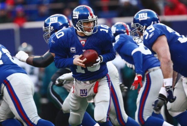 EAST RUTHERFORD, NJ -  JANUARY 11:  Eli Manning #10 of the New York Giants looks to hand off the ball against the Philadelphia Eagles during the NFC Divisional Playoff Game on January 11, 2009 at Giants Stadium in East Rutherford, New Jersey.  The Eagles 