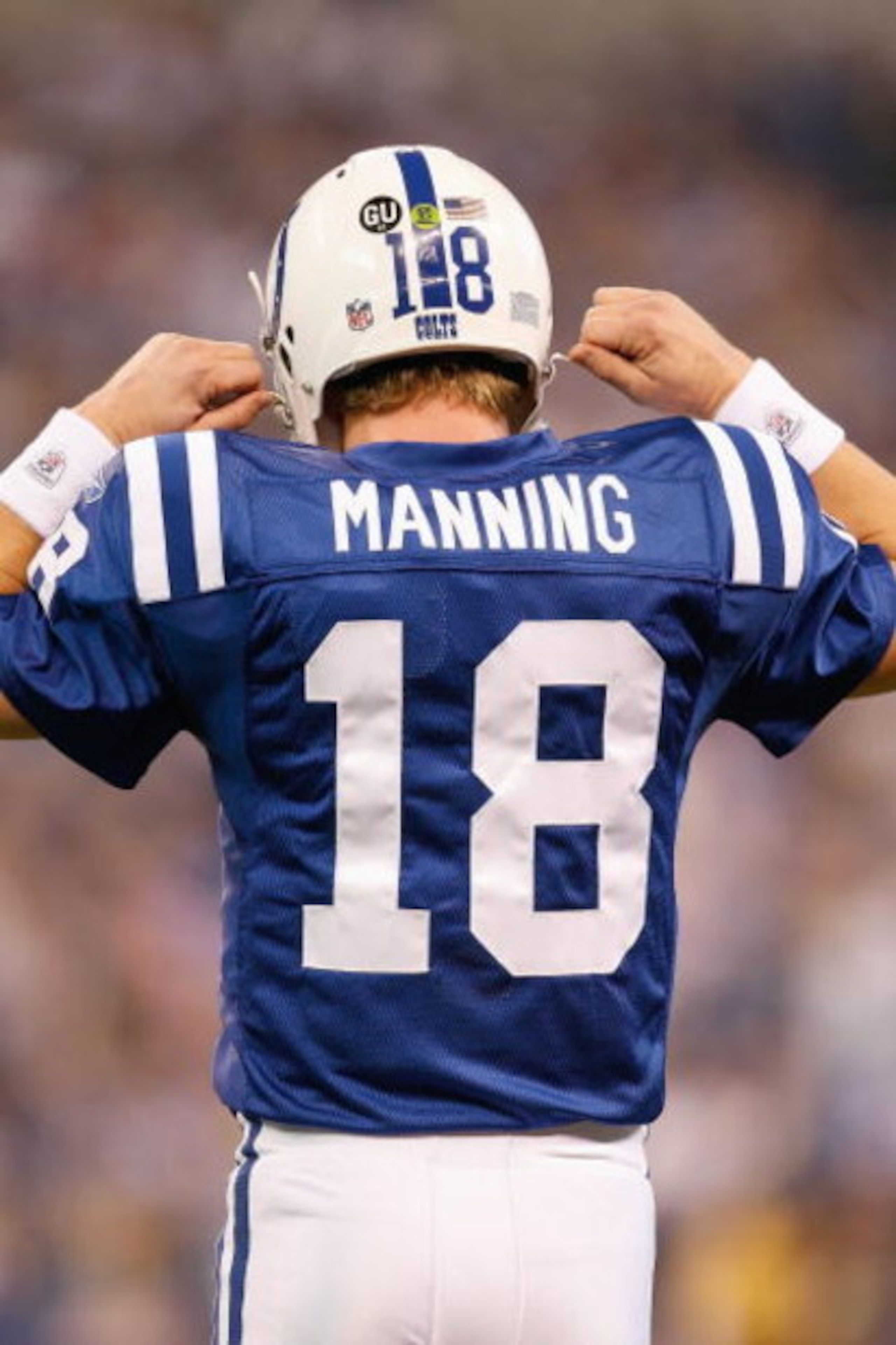 INDIANAPOLIS - DECEMBER 28:  Quarterback Peyton Manning #18 of the Indianapolis Colts unsnaps his helmet during the game against the Tennessee Titans on December 28, 2008 at Lucas Oil Stadium in Indianapolis, Indiana. (Photo by: Jamie Squire/Getty Images)