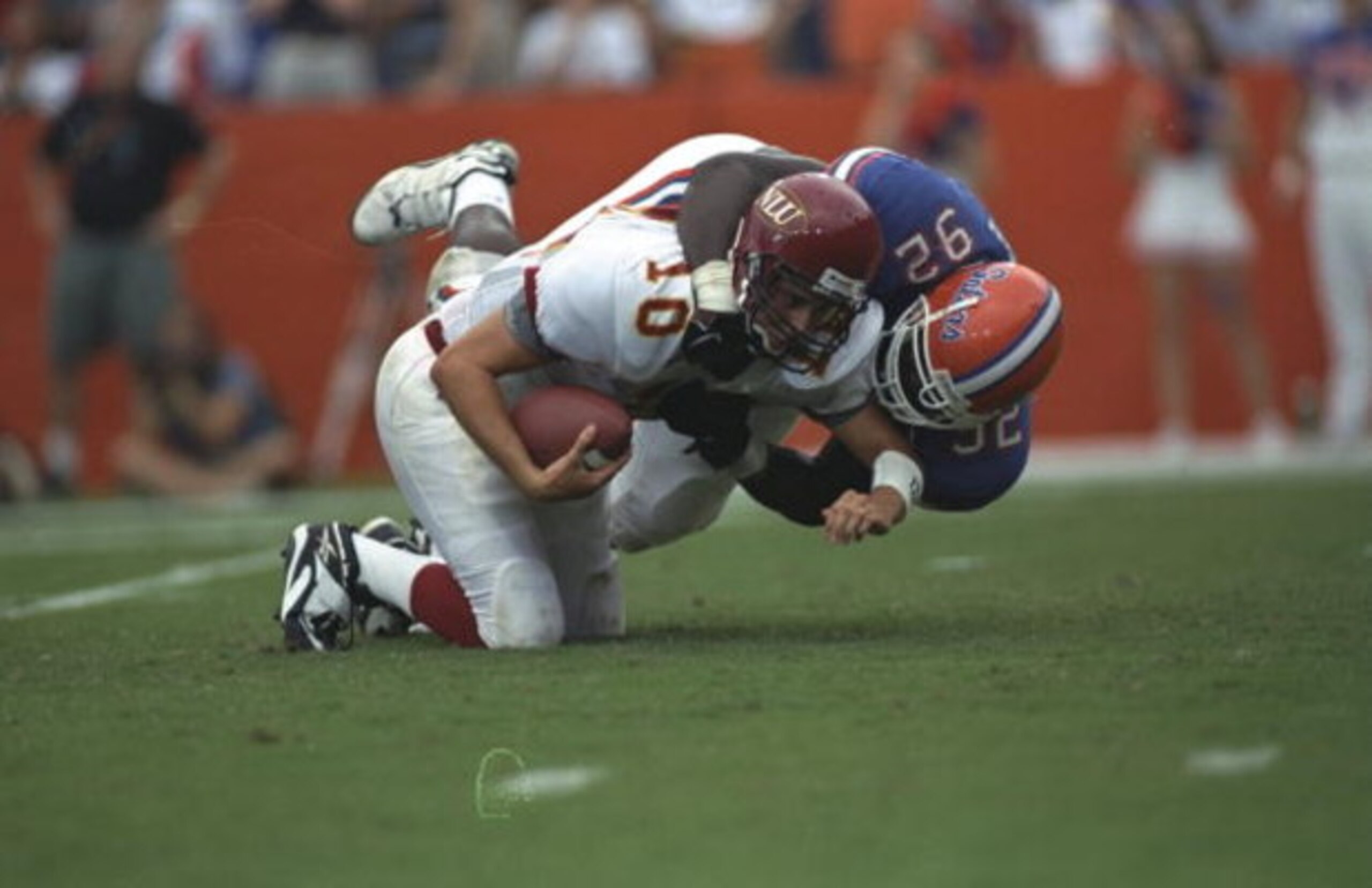 12 Sep 1998: Andres Vige #10 the N.E Louiisana is tackled by Reggie McGrew #92 of the Florida Gators at Folrida Field in Gainsville, Florida. Florida Gators defeated N,E Louisiana 12 Sep 1998: Andres Vige #10 the N.E Louiisana is tackled by Reggie McGrew #92 of the Florida Gators at Folrida Field in Gainsville, Florida. Florida Gators defeated N,E Louisiana