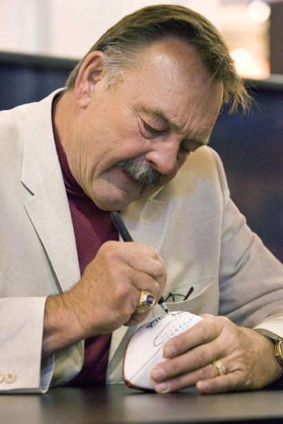 NEW ORLEANS - MAY 19: 2008 Pro Football Hall of Fame member and legendary Chicago Bears linebacker Dick Butkus takes time to sign footballs for fans in the Fox Cable Networks' booth at the The Cable Show in the Ernest N. Morial Convention Center on May 19
