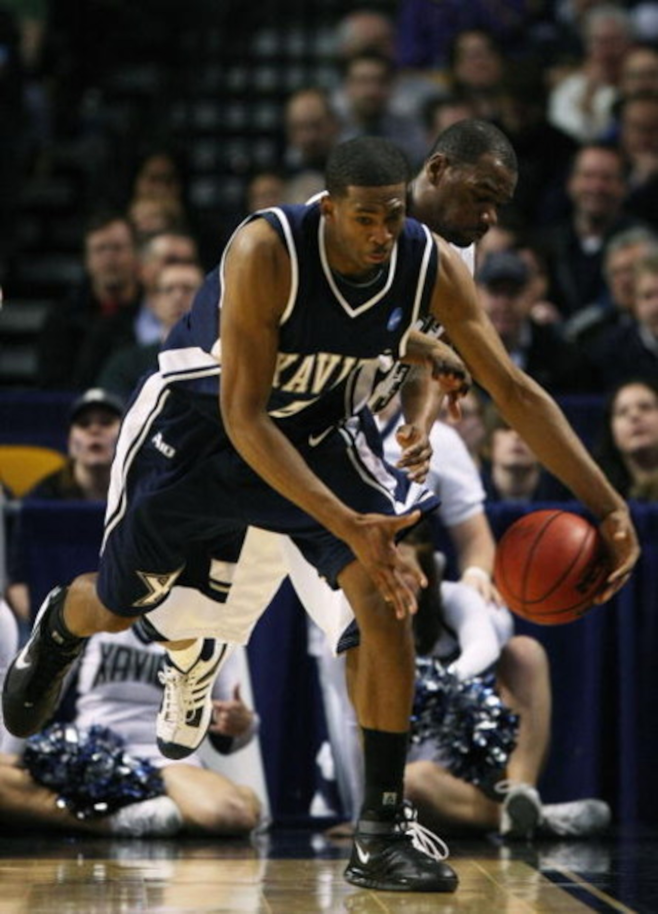 BOSTON - MARCH 26:  Sam Young #23 of the Pittsburgh Panthers and Derrick Brown #5 of the Xavier Musketeers fight to keep the ball in bounds during the NCAA Men's Basketball Tournament East Regionals at TD Banknorth Garden on March 26, 2009 in Boston, Mass