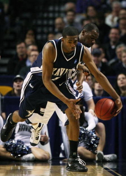 BOSTON - MARCH 26:  Sam Young #23 of the Pittsburgh Panthers and Derrick Brown #5 of the Xavier Musketeers fight to keep the ball in bounds during the NCAA Men's Basketball Tournament East Regionals at TD Banknorth Garden on March 26, 2009 in Boston, Mass