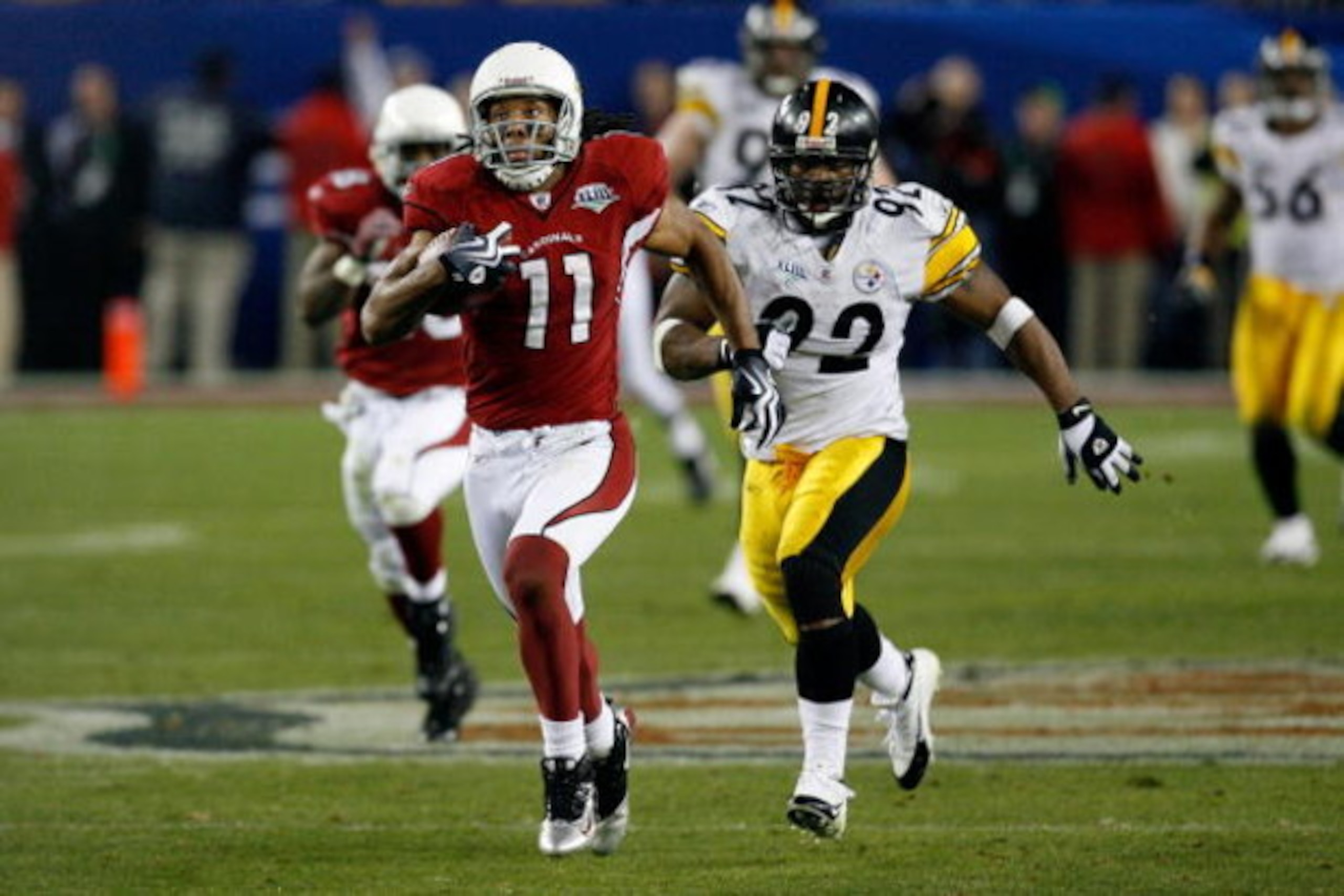 TAMPA, FL - FEBRUARY 01:  Wide receiver Larry Fitzgerald #11 of the Arizona Cardinals scores a 64-yard touchdown reception in the fourth quarter against James Harrison #92 of the Pittsburgh Steelers during Super Bowl XLIII on February 1, 2009 at Raymond J
