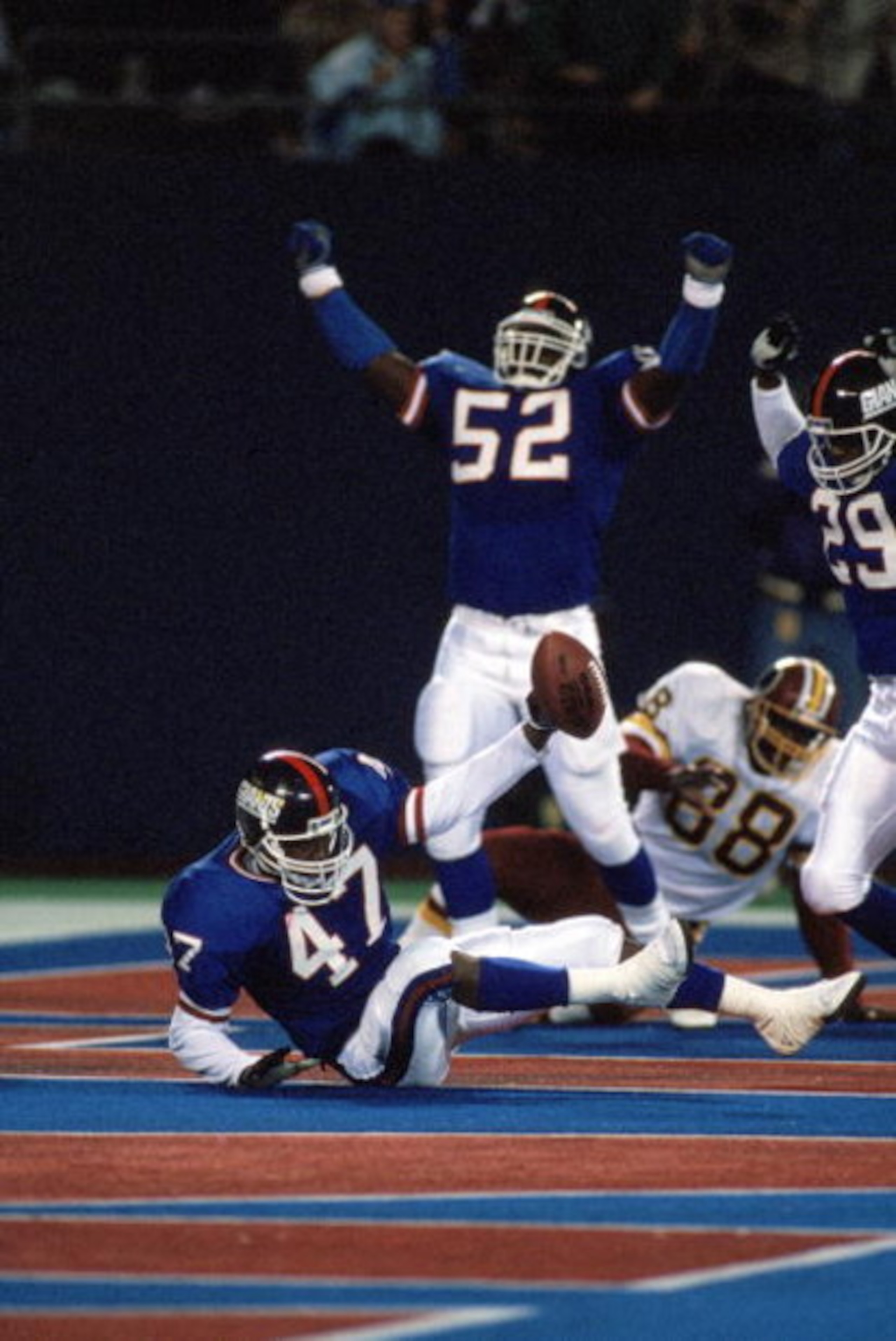 EAST RUTHERFORD, NJ - OCTOBER 28:  Linebacker Pepper Johnson #52 and safety Myron Guyton #29 of the New York Giants celebrate after the end zone interception by teammate Greg Jackson #47 during a game against the Washington Redskins at Giants Stadium Octo