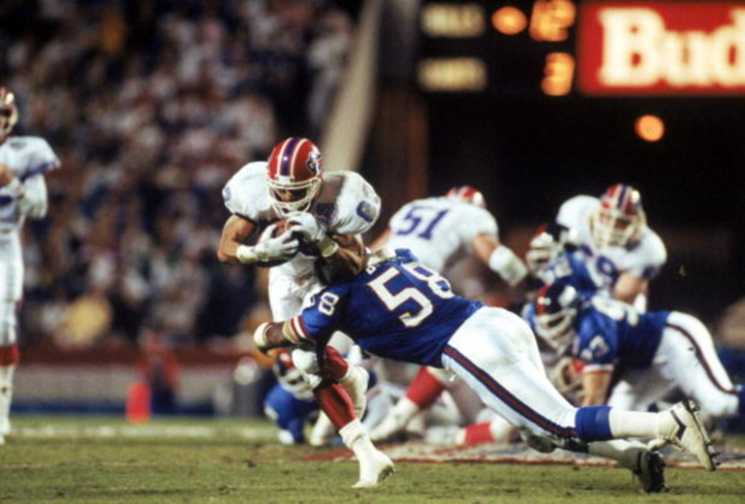 TAMPA, FL - JANUARY 27:  Linebacker Carl Banks #58 of the New York Giants tackles wide receiver Andre Reed #83 of the Buffalo Bills in the second quarter of Super Bowl XXV at Tampa Stadium on January 27, 1991 in Tampa, Florida.  The Giants won 20-19.  (Ph