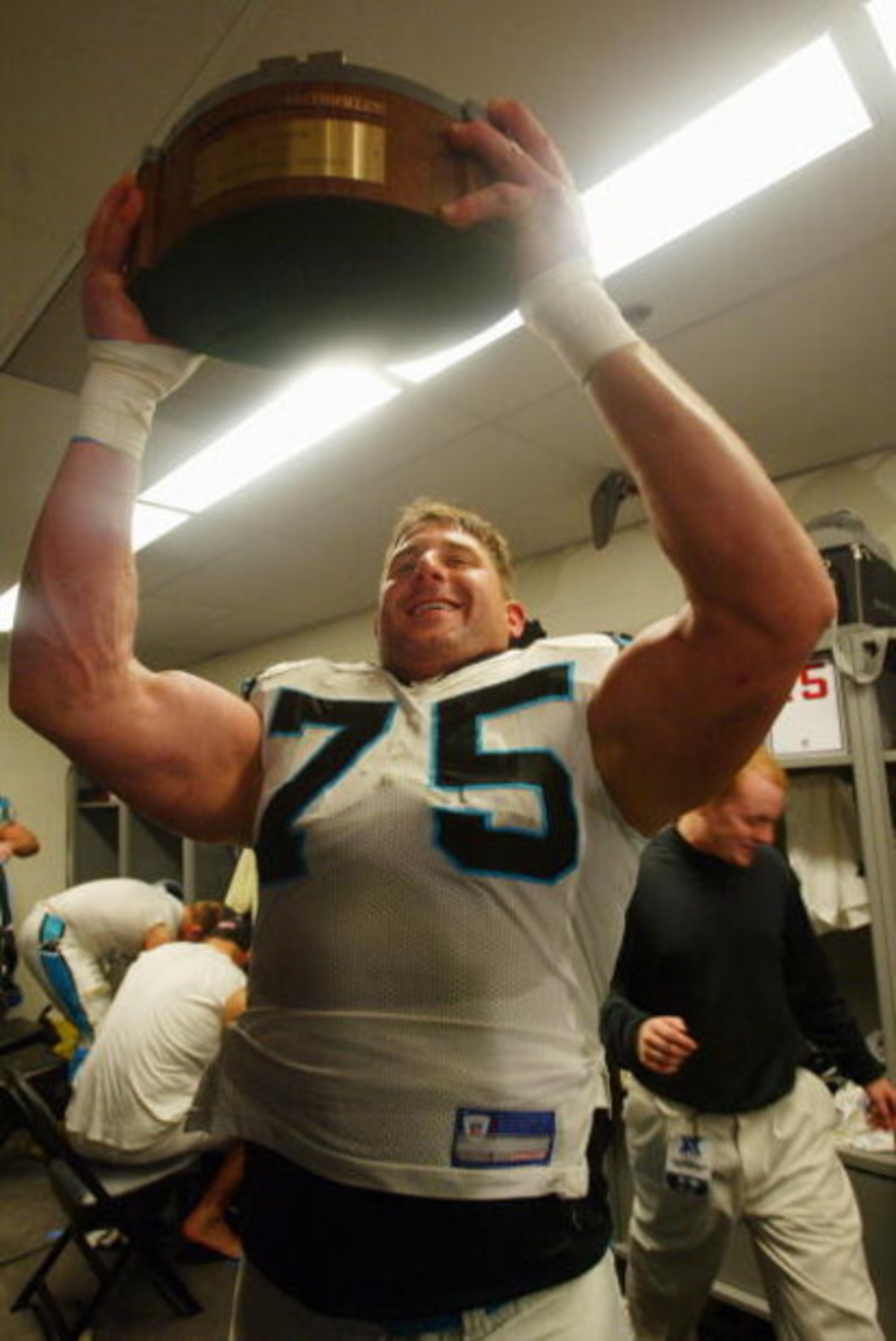 PHILADELPHIA - JANUARY 18:  Tackle Todd Steussie #75 of the Carolina Panthers holds up the NFC Championship Trophy after the Panthers defeated the Philadelphia Eagles on January 18, 2004 at Lincoln Financial Field in Philadelphia, Pennsylvania. The Panthe