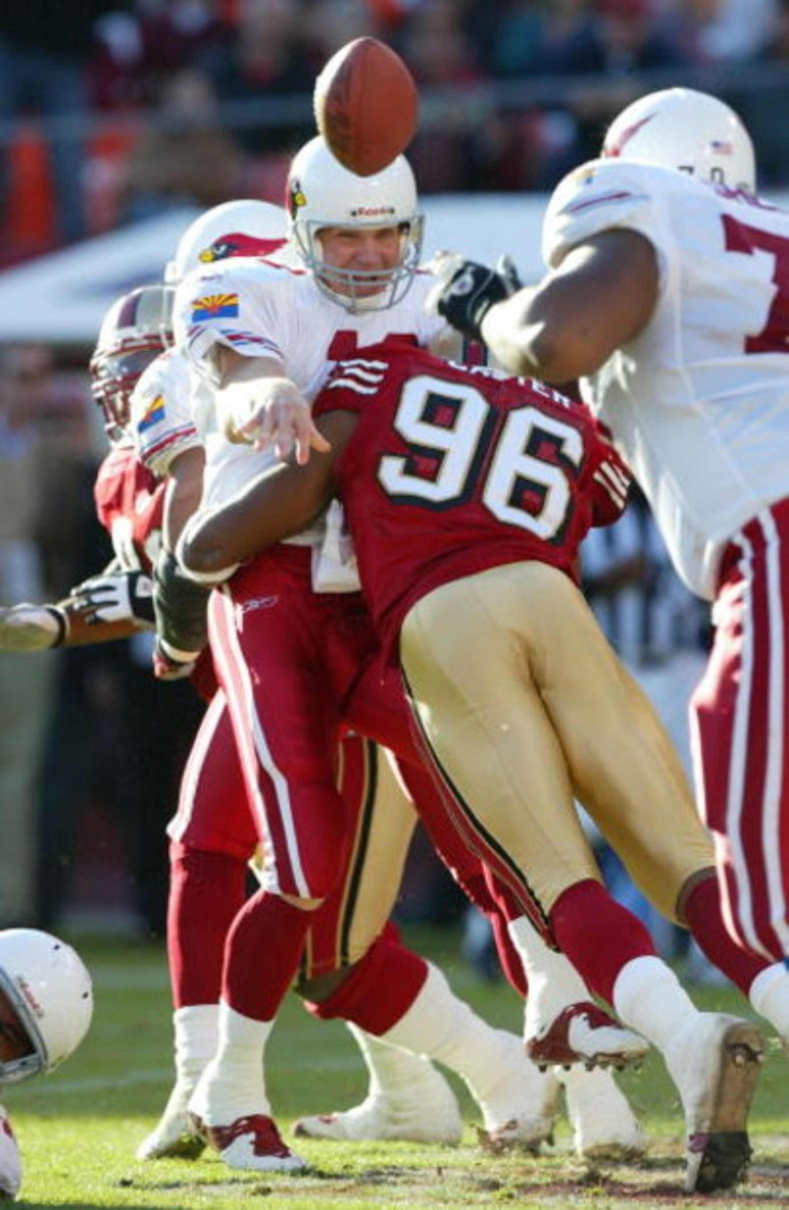 SAN FRANCISCO - DECEMBER 7:  Andre Carter #96 of the San Francisco 49ers hits quaterback Josh McCown #12 of the Arizona Cardinals for a saftey during an NFL game on December 7, 2003 at Candelstick Park in San Francisco, California.  (Photo by Jed Jacobsoh