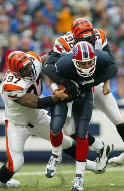 ORCHARD PARK, NY - OCTOBER 5:  John Thornton #97 and Duane Clemons #92 of the Cincinnati Bengals sack Drew Bledsoe #11 of the Buffalo Bills on October 5, 2003 at Ralph Wilson Stadium in Orchard Park, New York.  The Bills defeated the Bengals 22-16. (Photo