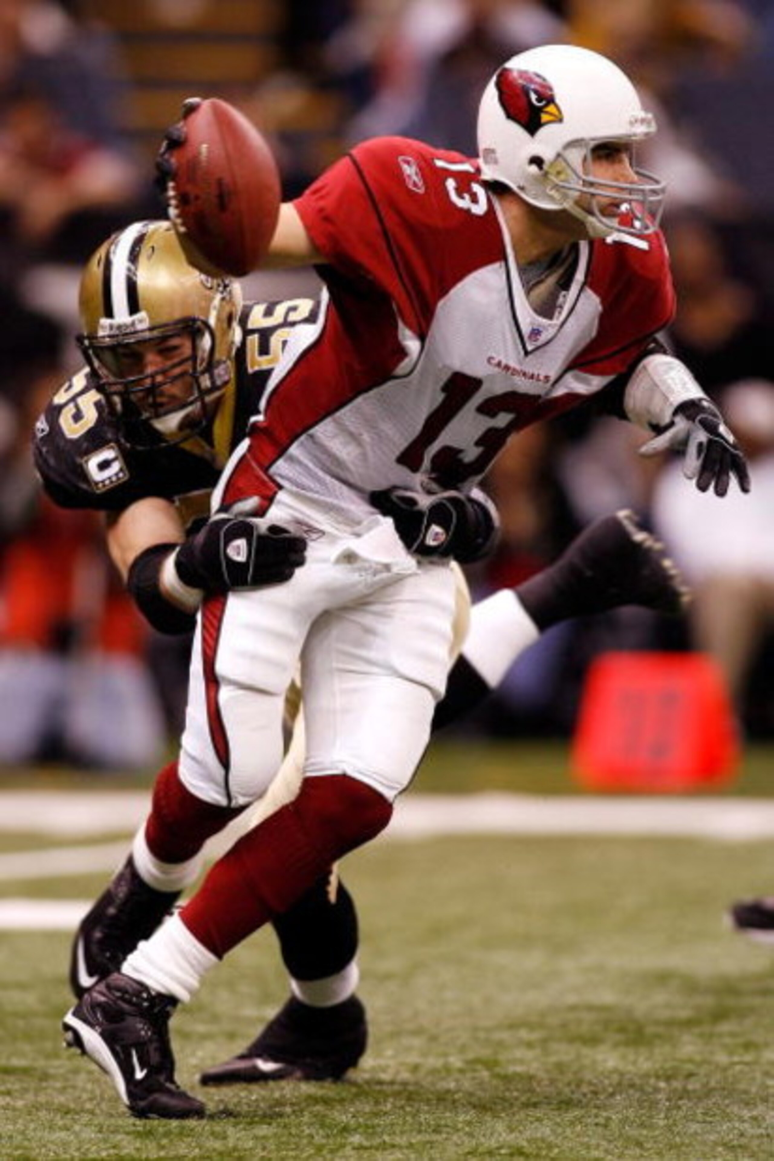 NEW ORLEANS - DECEMBER 16: Quarterback Kurt Warner #13 of the Arizona Cardinals is sacked by Scott Fujita #55 of the New Orleans Saints on December 16, 2007 at the Louisiana Superdome in New Orleans, Louisiana. The Saints defeated the Cardinals 31-24.   (