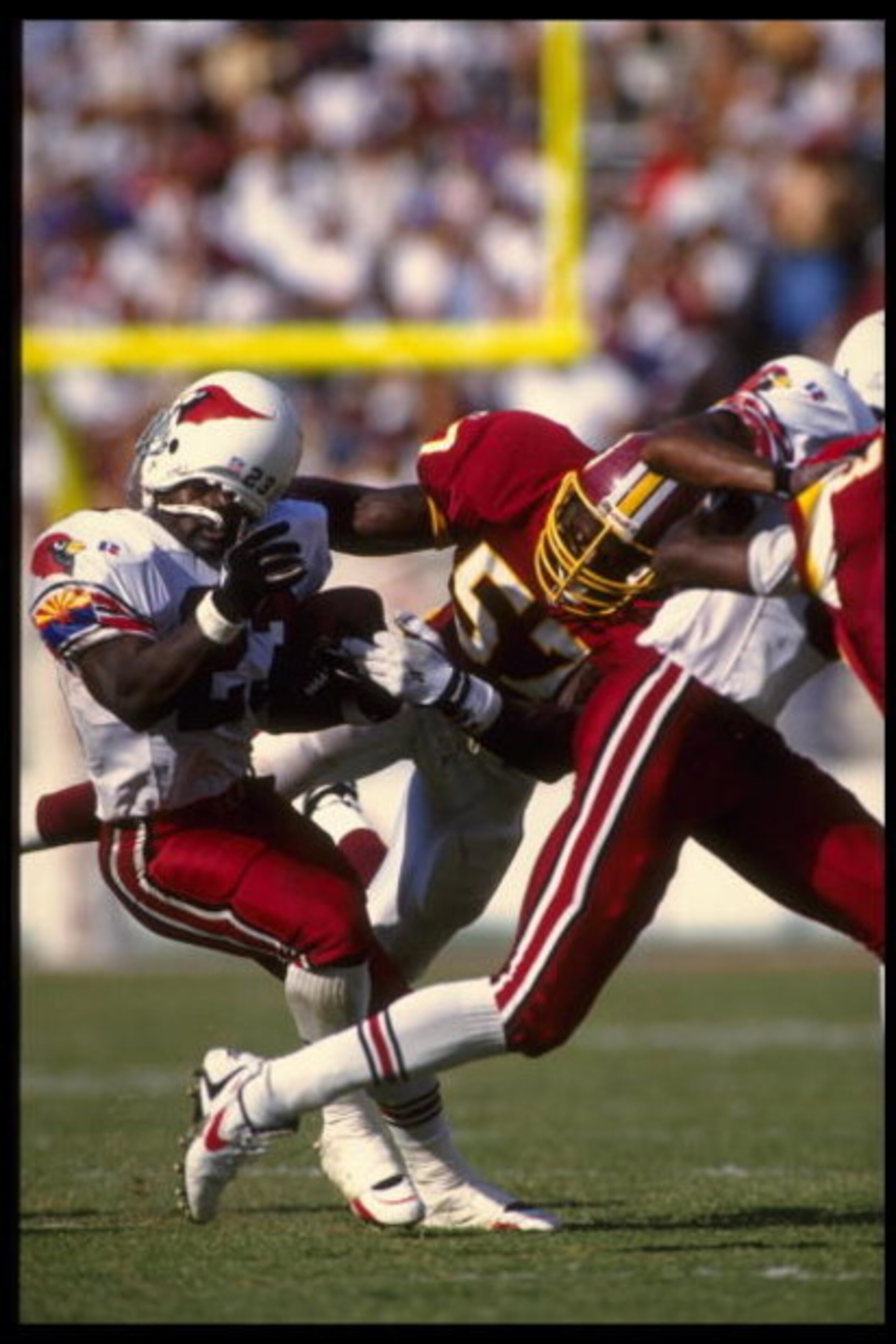 15 Oct 1995:  Running back Garrison Hearst of the Arizona Cardinals is tackled by the facemack by linebacker Ken Harvey of the Washington Redskins during the Cardinals 24-20 win at Sun Devil Stadium in Tempe, Arizona.  Mandatory Credit:  Otto Greule/Allsp