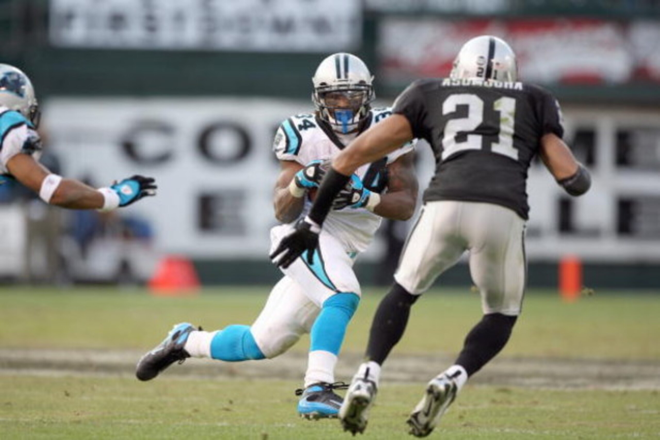 OAKLAND - NOVEMBER 9:  DeAngelo Williams #34 of the Carolina Panthers carries the ball against Nnamdi Asomugha #21 of the Oakland Raiders at the Oakland-Alameda County Coliseum on November 9, 2008 in Oakland, California. (Photo by: Jed Jacobsohn/Getty Ima