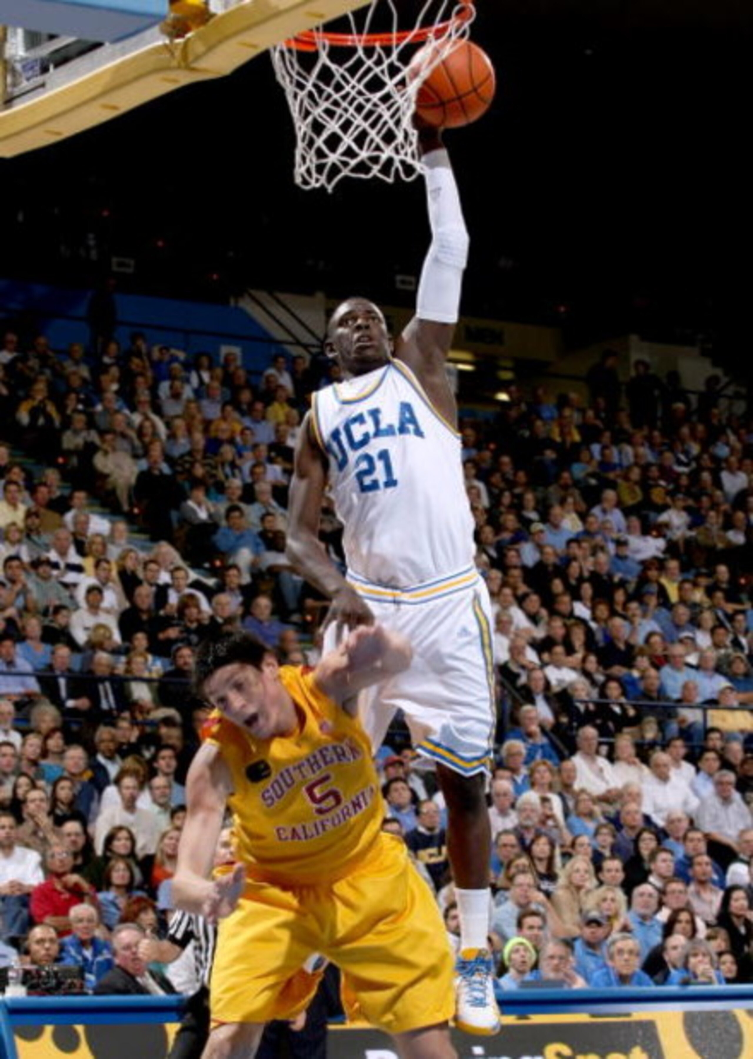 WESTWOOD, CA - FEBRUARY 04: Jrue Holiday #21 of the UCLA Bruins shoots over Nikola Vucevic #5 of the USC Trojans on February 4, 2009 at Pauley Pavillion in Westwood, California. UCLA won 76-60. (Photo by Stephen Dunn/Getty Images) WESTWOOD, CA - FEBRUARY 04: Jrue Holiday #21 of the UCLA Bruins shoots over Nikola Vucevic #5 of the USC Trojans on February 4, 2009 at Pauley Pavillion in Westwood, California. UCLA won 76-60. (Photo by Stephen Dunn/Getty Images)