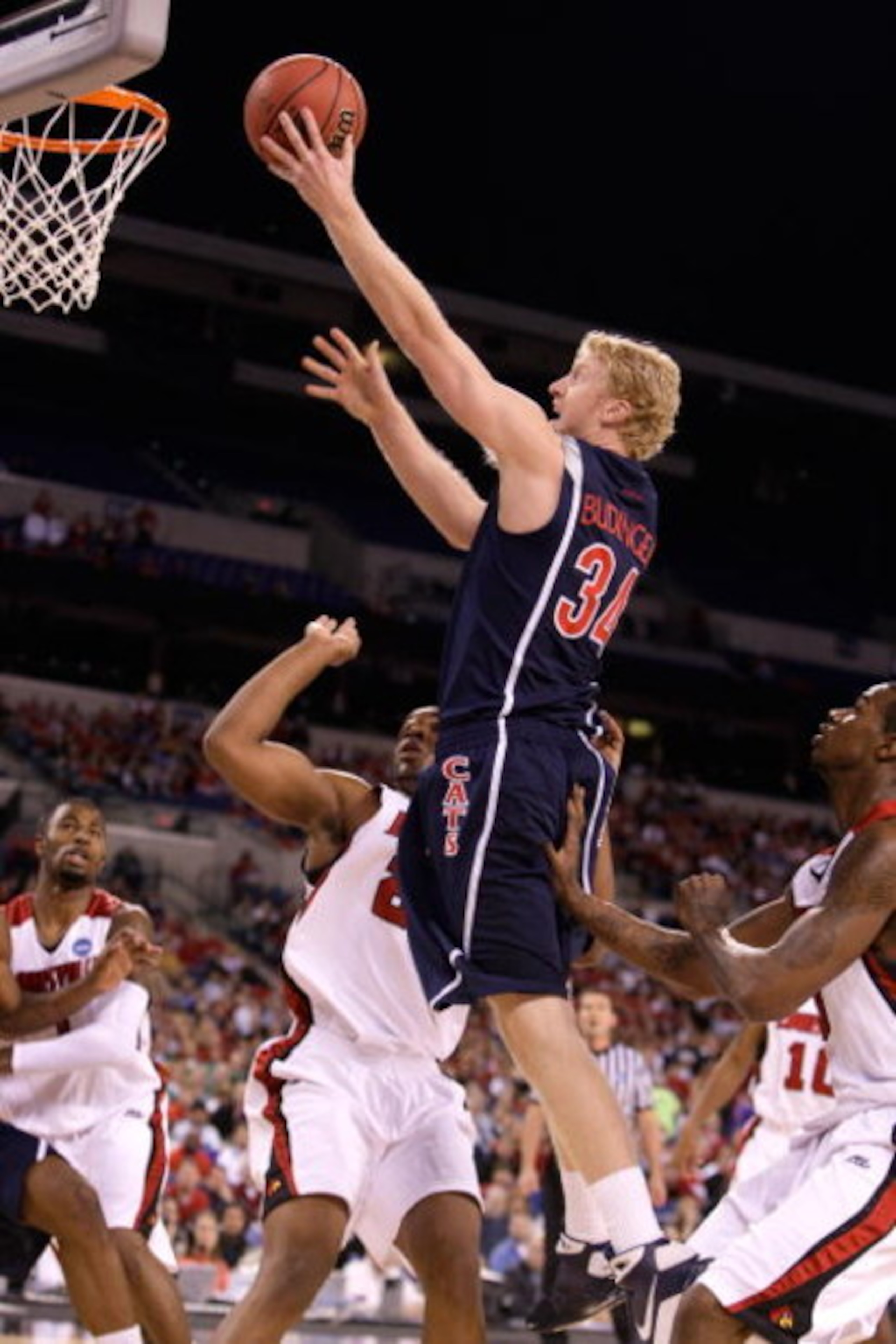INDIANAPOLIS - MARCH 27: Chase Budinger #34 of the Arizona Wildcats attempts a shot against the Louisville Cardinals during the third round of the NCAA Division I Men's Basketball Tournament at the Lucas Oil Stadium on March 27, 2009 in Indianapolis, In INDIANAPOLIS - MARCH 27: Chase Budinger #34 of the Arizona Wildcats attempts a shot against the Louisville Cardinals during the third round of the NCAA Division I Men's Basketball Tournament at the Lucas Oil Stadium on March 27, 2009 in Indianapolis, In