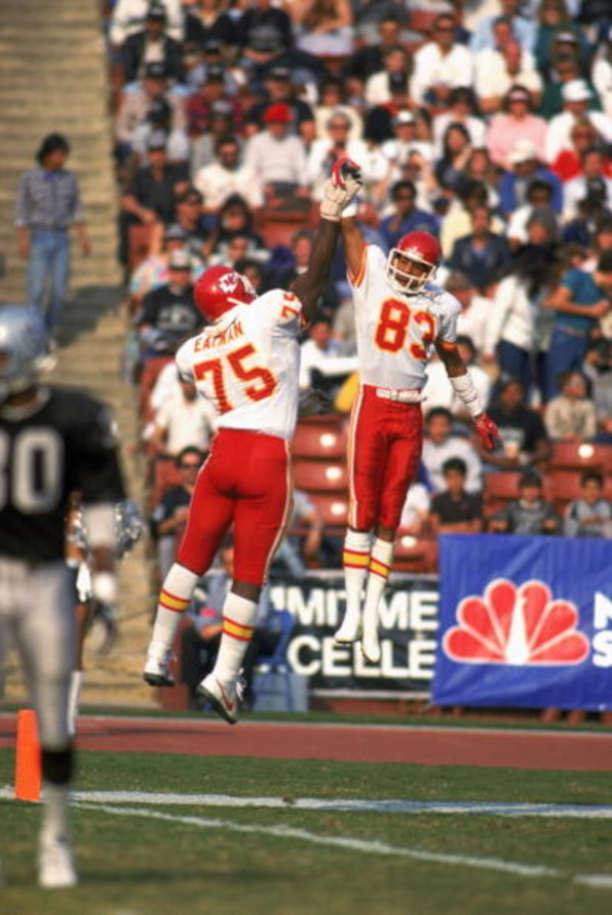 LOS ANGELES - 1986:  Wide receiver Stephone Paige #83 and Irv Eatman #75 of the Kansas City Chiefs celebrate with a high five during a 1986 NFL game against the Los Angeles Raiders at the LA Memorial Coliseum in Los Angeles, California.  The Raiders defea
