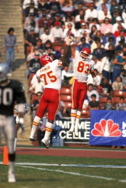 LOS ANGELES - 1986: Wide receiver Stephone Paige #83 and Irv Eatman #75 of the Kansas City Chiefs celebrate with a high five during a 1986 NFL game against the Los Angeles Raiders at the LA Memorial Coliseum in Los Angeles, California. The Raiders defea LOS ANGELES - 1986: Wide receiver Stephone Paige #83 and Irv Eatman #75 of the Kansas City Chiefs celebrate with a high five during a 1986 NFL game against the Los Angeles Raiders at the LA Memorial Coliseum in Los Angeles, California. The Raiders defea
