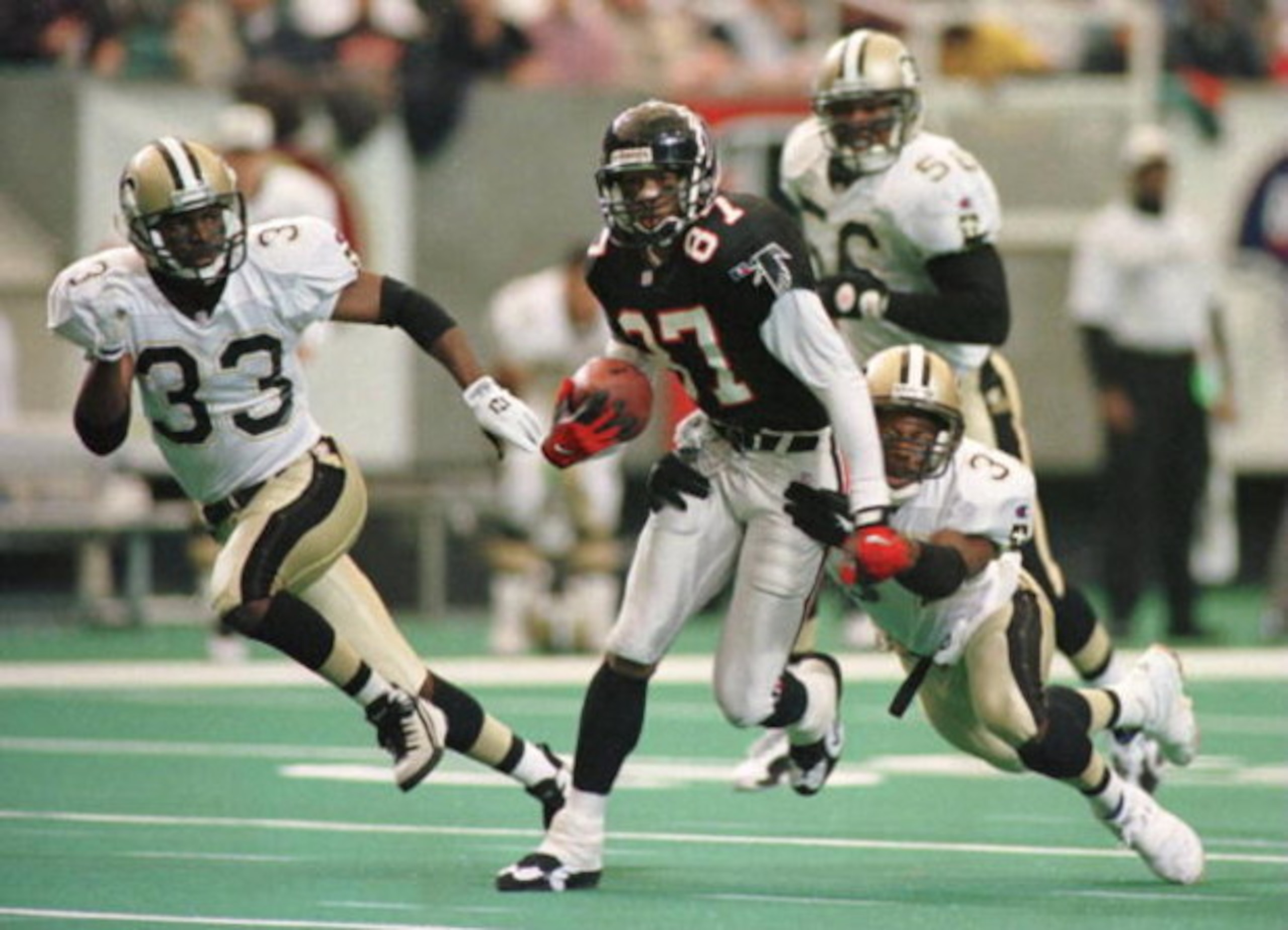 10 DEC 1995:  NEW ORLEANS SAINTS DEFENDERS TYRONE HUGHES #33, ERNEST DIXON #56 AND JIMMY SPENCER #37 ATTEMPT TO STOP ATLANTA FALCONS WIDE RECEIVER BERT EMANUEL #87 IN THE SECOND QUARTER AT THE GEORGIA DOME IN ATLANTA, GEORGIA.  Mandatory Credit: Matthew S