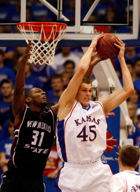 LAWRENCE, KS - DECEMBER 03: Cole Aldrich #45 of the Kansas Jayhawks grabs a rebound as Wendell McKines #31 of the New Mexico State Aggies defends during the second half of the game on December 3, 2008 at Allen Fieldhouse in Lawrence, Kansas. (Photo by Jam