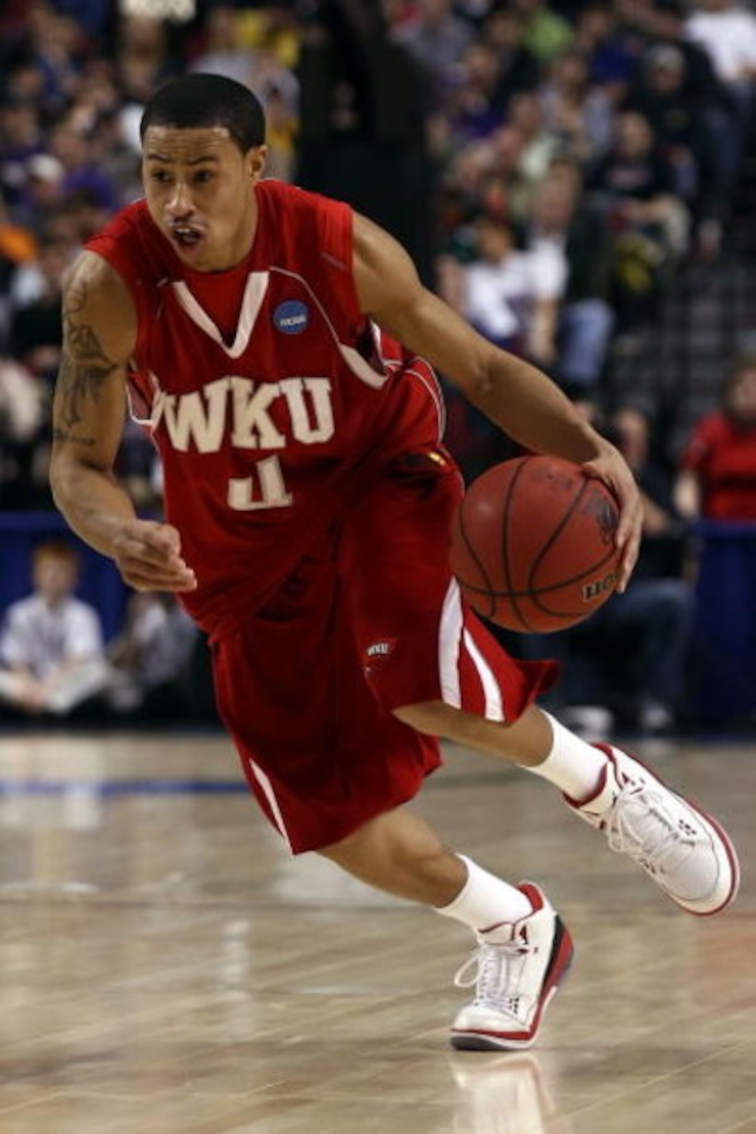 PORTLAND, OR - MARCH 21:  A.J. Slaughter #4 of the Western Kentucky Hilltoppers moves the ball while taking on the Gonzaga Bulldogs during the second round of the NCAA Division I Men's Basketball Tournament at the Rose Garden on March 21, 2009 in Portland