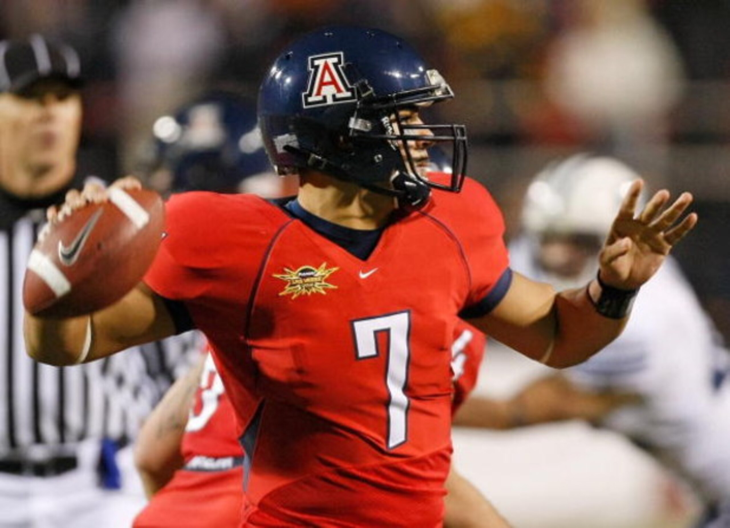LAS VEGAS - DECEMBER 20:  Quarterback Willie Tuitama #7 of the Arizona Wildcats looks to throw a pass against the Brigham Young University Cougars during the Pioneer Las Vegas Bowl at Sam Boyd Stadium December 20, 2008 in Las Vegas, Nevada. Arizona won 31