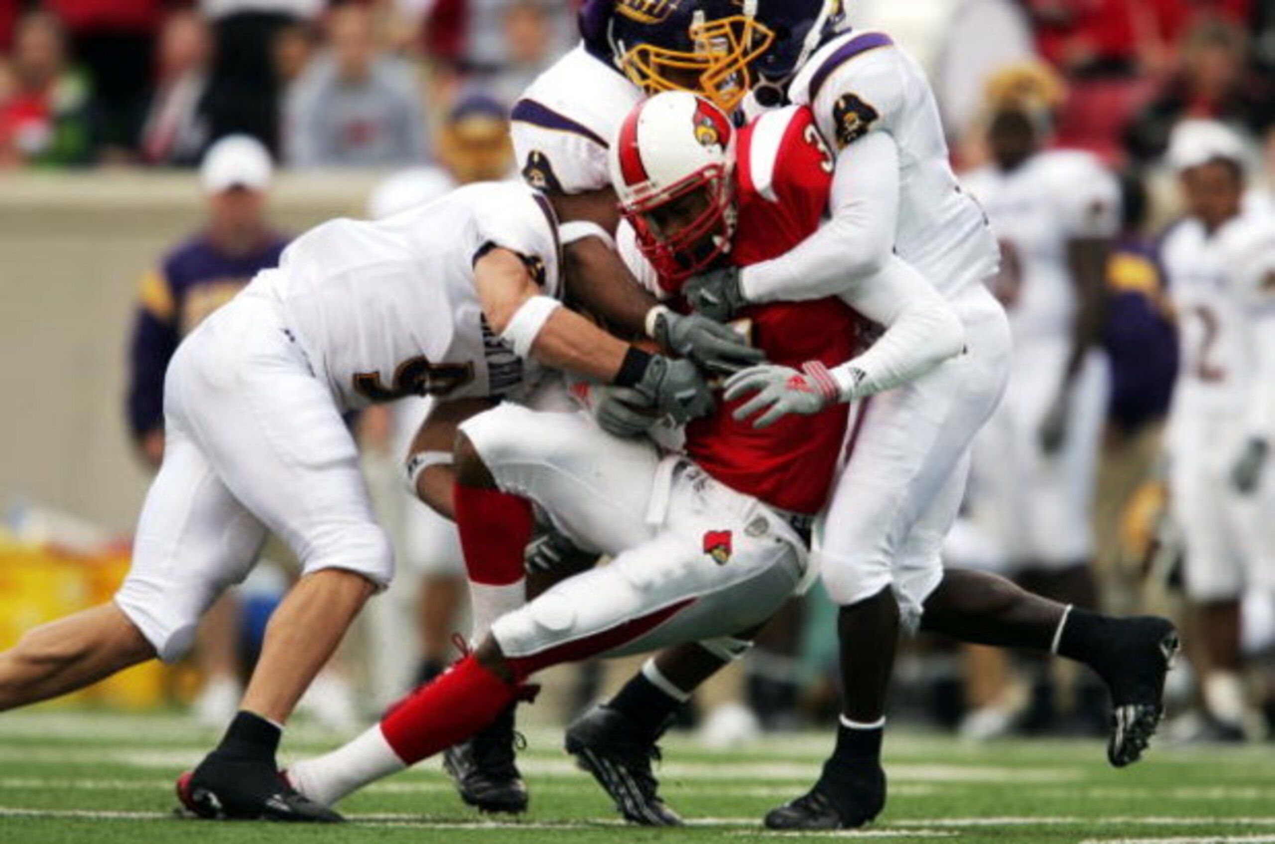 LOUISVILLE,KY - OCTOBER 2:  J.R. Russell #3 of Louisville runs after a reception against East Carolina during the game at Papa John's Stadium on October 2, 2004 in Louisville, Kentucky.  (Photo by Andy Lyons/Getty Images)