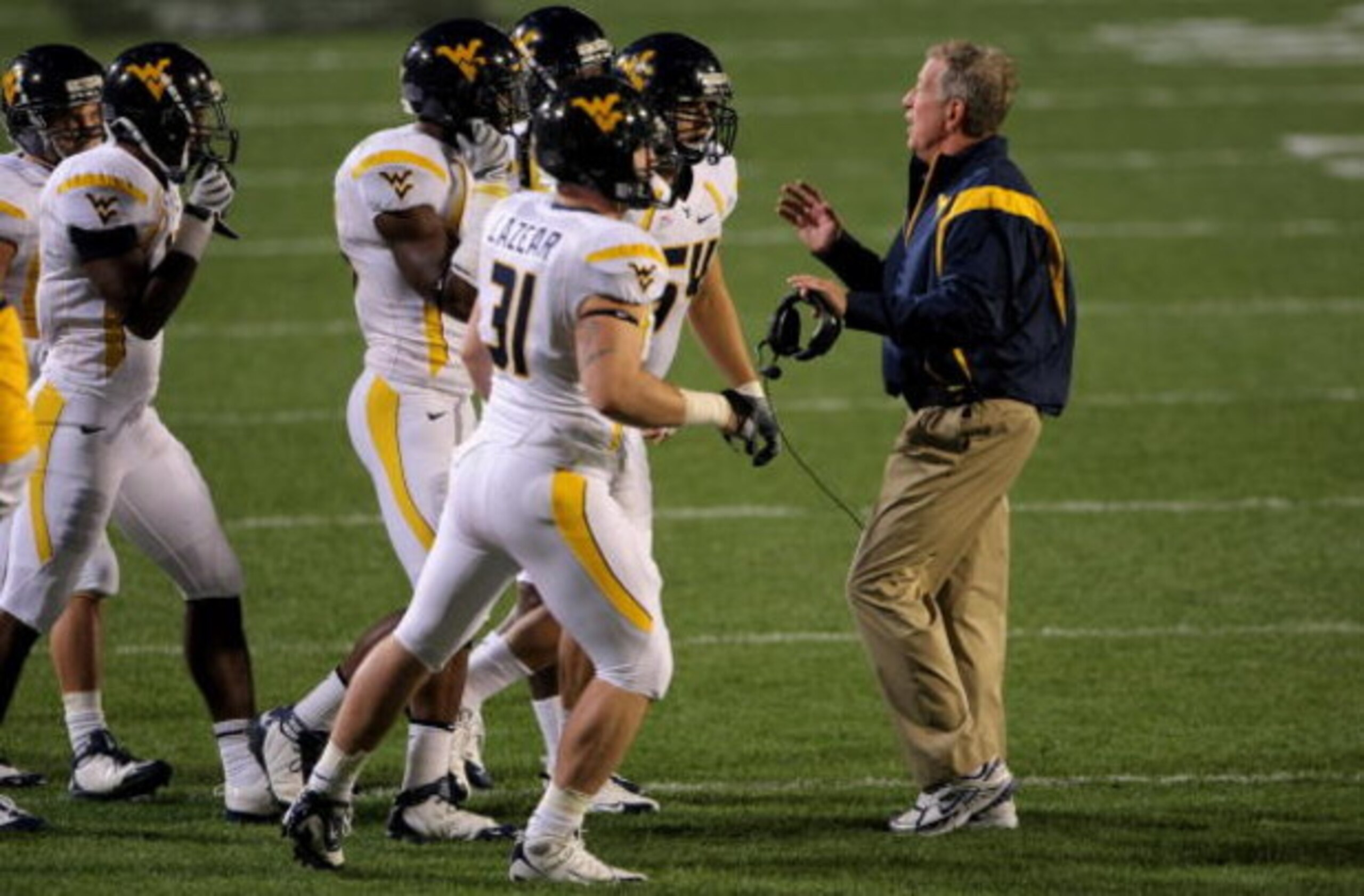 BOULDER, CO - SEPTEMBER 18:  Head coach Bill Stewart of the West Virginia Mountaineers leads his team against the Colorado Buffaloes at Folsom Field on September 18, 2008 in Boulder, Colorado. Colorado defeated West Virginia 17-14 in overtime.  (Photo by 