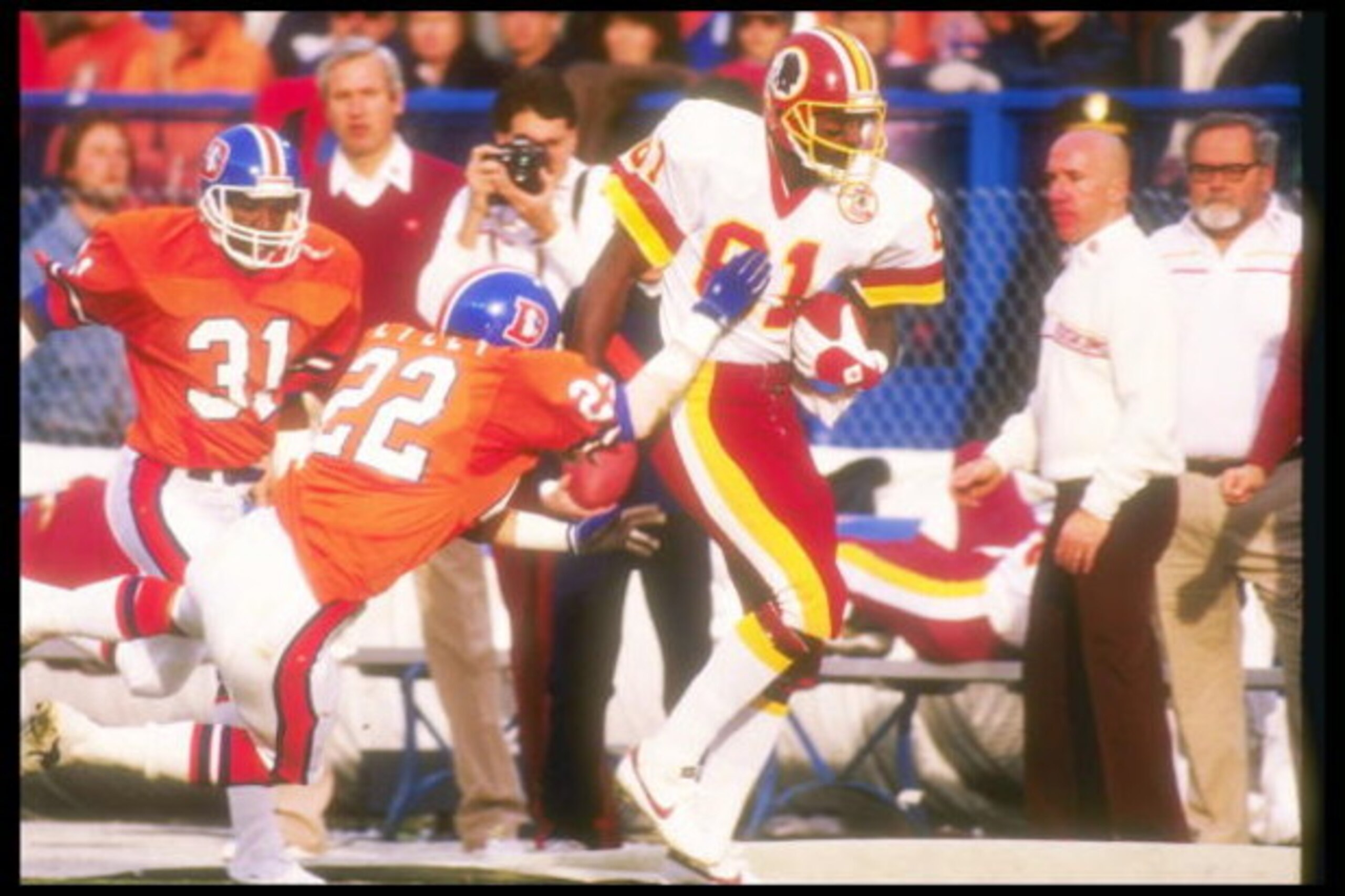 31 Jan 1988:  Defensive lineman Tony Lilly #22 of the Denver Broncos tries to stop wide receiver Art Monk #81 of the Washington Redskins during the Super Bowl XXII game at the Jack Murphy Stadium in San Diego, California.  The Redskins won, 42-10.  Mandat