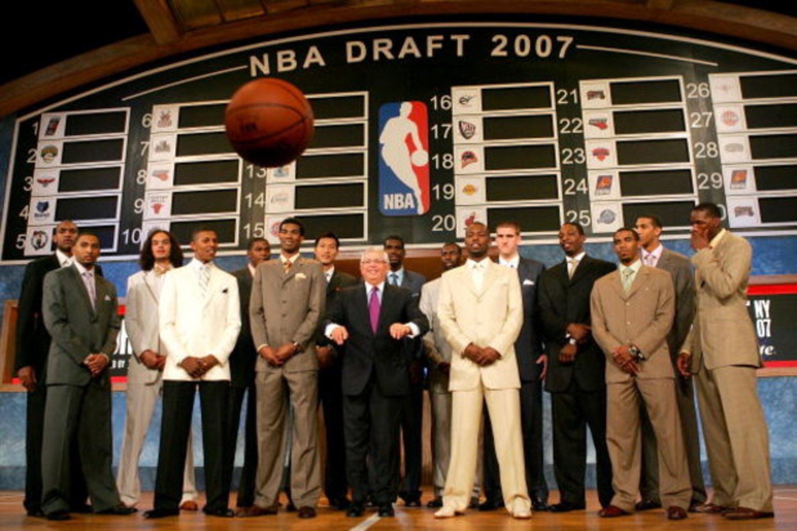 NEW YORK - JUNE 28: NBA Commissioner David Stern (C) throws a basketball at the media while posing with (L-R) Al Horford, Acie Law IV, Joakim Noah, Nick Young, Kevin Durant, Corey Brewer, Yi Jianlian, Greg den, Julian Wright, Rodney Stuckey, Spencer Hawes