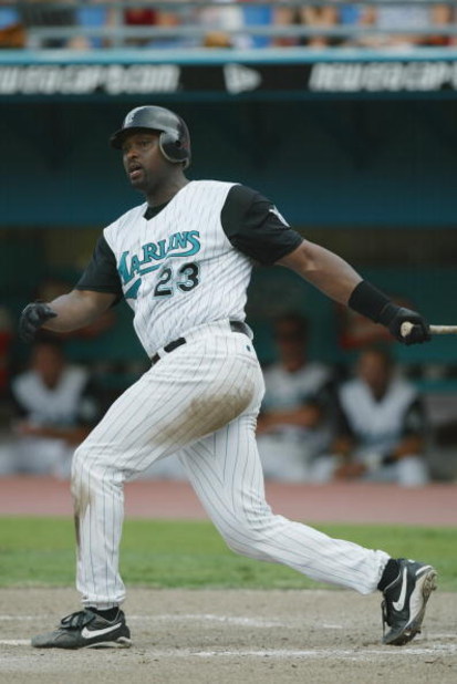 MIAMI - JULY 21:  Catcher Charles Johnson #23 of the Florida Marlins swings the bat during the MLB game against the Montreal Expos on July 21, 2002 at Pro Player Stadium in Miami, Florida.  The Expos won 4-0.  (Photo By Eliot J. Schechter/Getty Images)