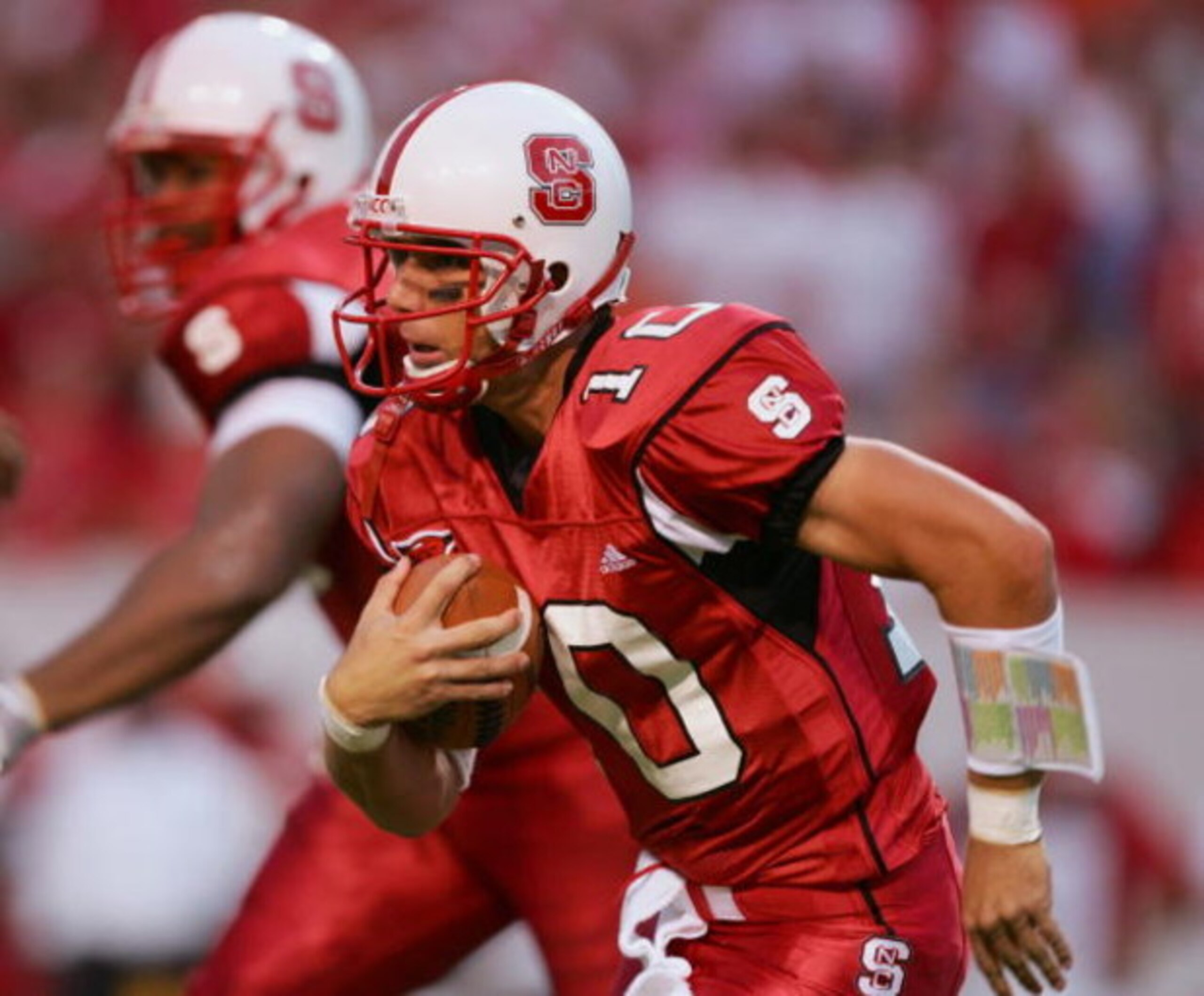 RALEIGH, NC - SEPTEMBER 4:  Quarterback Jay Davis #10 of the North Carolina State University Wolfpack scrambles with the ball against the Virginia Polytechnic Institute and State University Hokies at Carter-Finley Stadium on September 4, 2005 in Raleigh, 