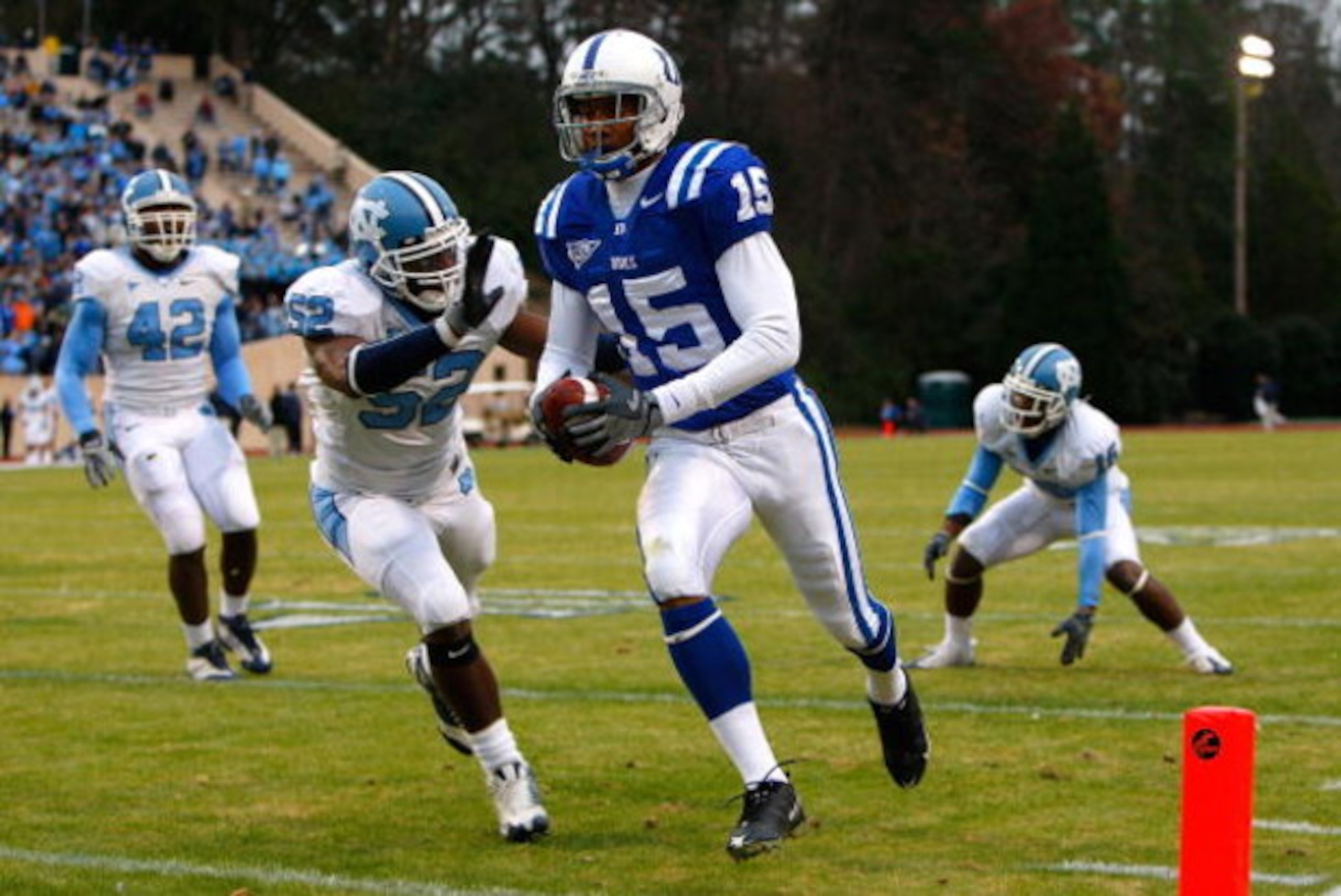 DURHAM, NC - NOVEMBER 29:  Receiver Eron Riley #15 of the Duke Blue Devils scores a touchdown past Quan Sturdivant #52 of the North Carolina Tar Heels during the game at Wallace Wade Stadium on November 29, 2008 in Durham, North Carolina.  (Photo by Kevin