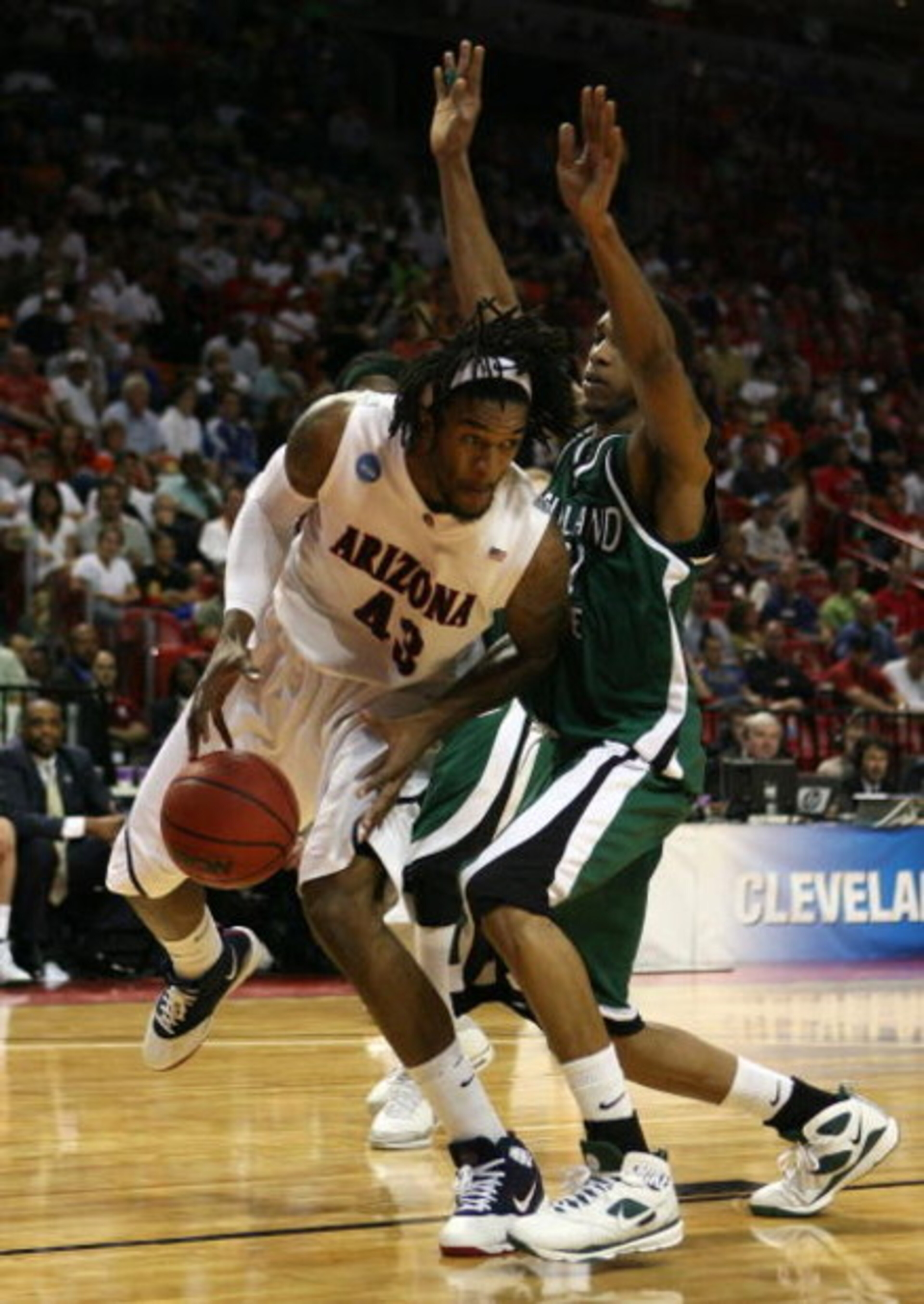 MIAMI - MARCH 22: Forward Jordan Hill #43 of the University of Arizona Wildcats is defended by forward George Tandy #21 of the Cleveland State University Vikings during the second round of the NCAA Division I Men's Basketball Tournament at the American MIAMI - MARCH 22: Forward Jordan Hill #43 of the University of Arizona Wildcats is defended by forward George Tandy #21 of the Cleveland State University Vikings during the second round of the NCAA Division I Men's Basketball Tournament at the American