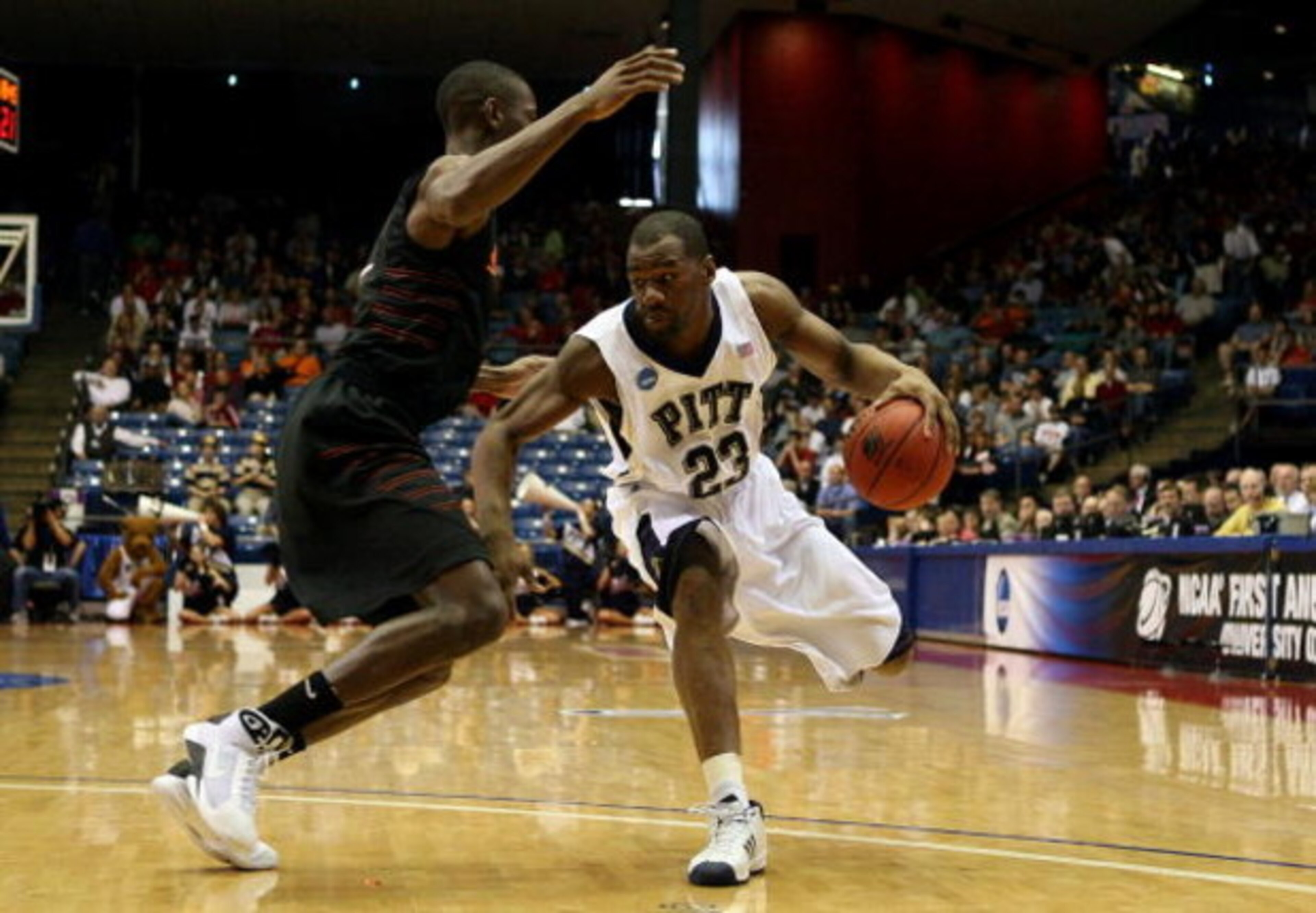 DAYTON, OH - MARCH 22: Sam Young #23 of the Pittsburgh Panthers handles the ball against Terrel Harris #1 of the Oklahoma State Cowboys during the second round of the NCAA Division I Men's Basketball Tournament at the University of Dayton Arena on March 2 DAYTON, OH - MARCH 22: Sam Young #23 of the Pittsburgh Panthers handles the ball against Terrel Harris #1 of the Oklahoma State Cowboys during the second round of the NCAA Division I Men's Basketball Tournament at the University of Dayton Arena on March 2